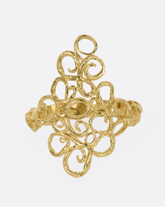 A yellow gold ring with filigree in the shape of a diamond at its center. Shown from the front.