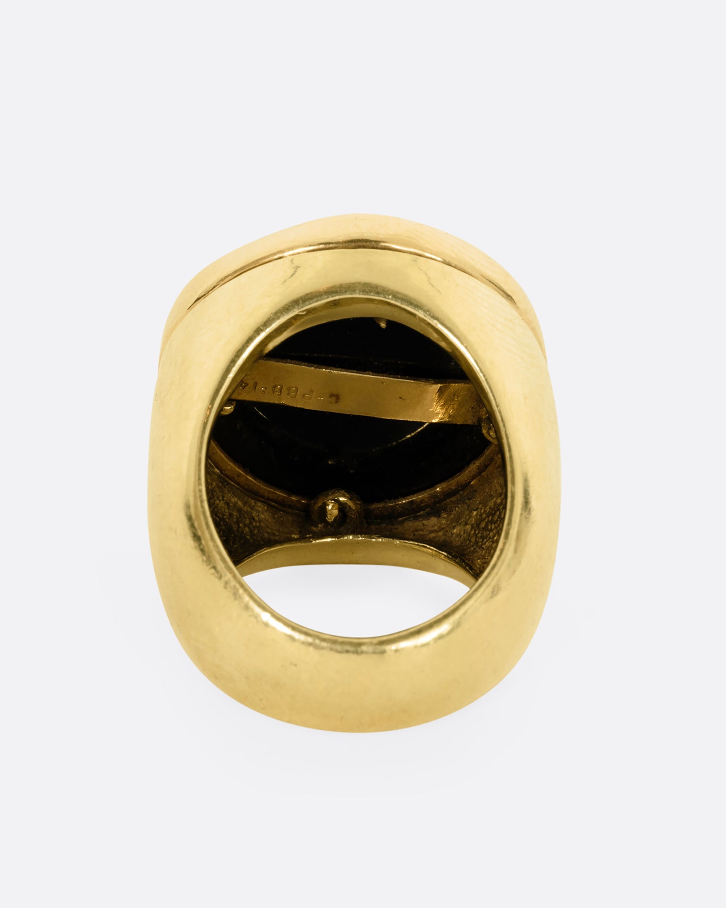 A yellow gold ring with a yin yang symbol made of onyx. Shown from the back.