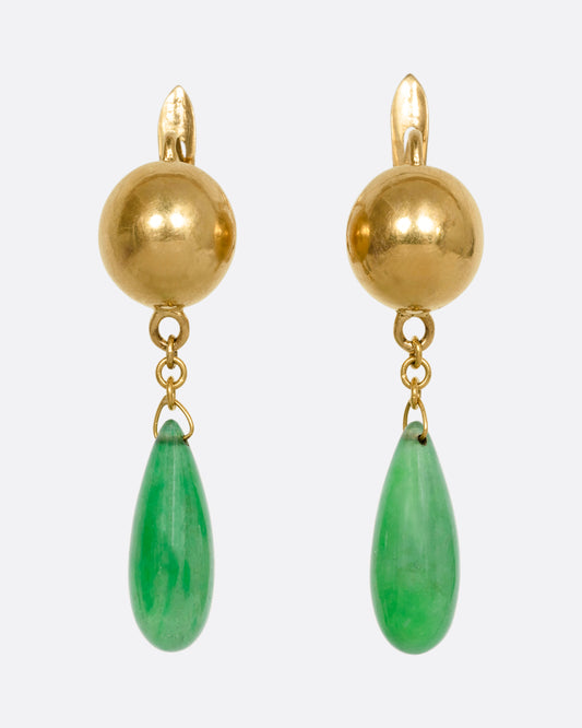 A pair of yellow gold ball earrings with teardrop jade drops. Shown from the front.