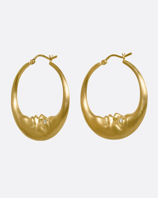 yellow gold crescent shaped oop earring with diamond eyes shown from the front