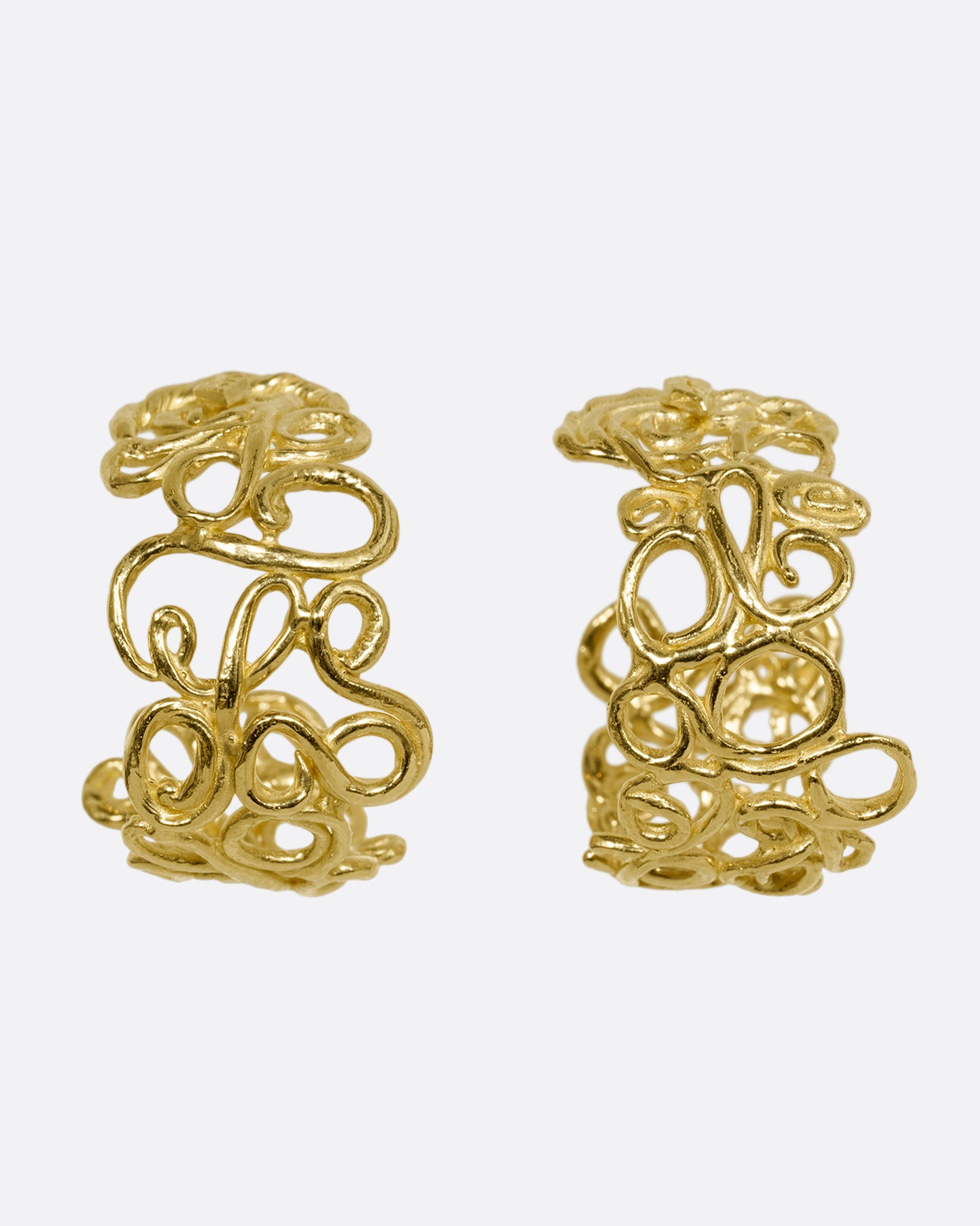 yellow gold swirl hoop earrings shown from the front