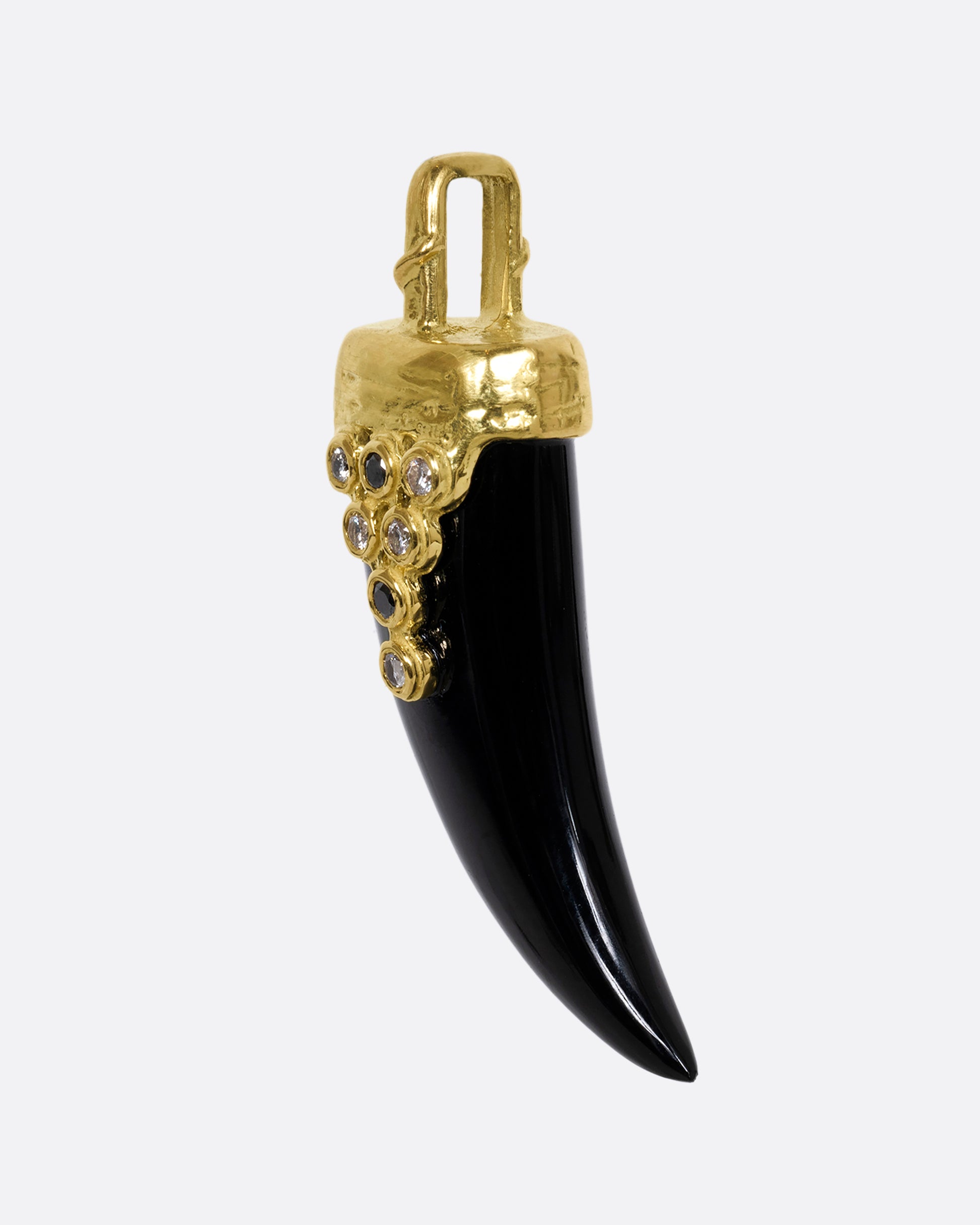 yellow gold tooth shaped onyx charm with black diamond and white diamond shown from the side