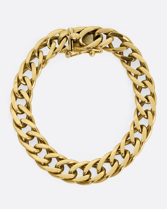 A yellow gold double curb chain bracelet. Shown closed, from above.