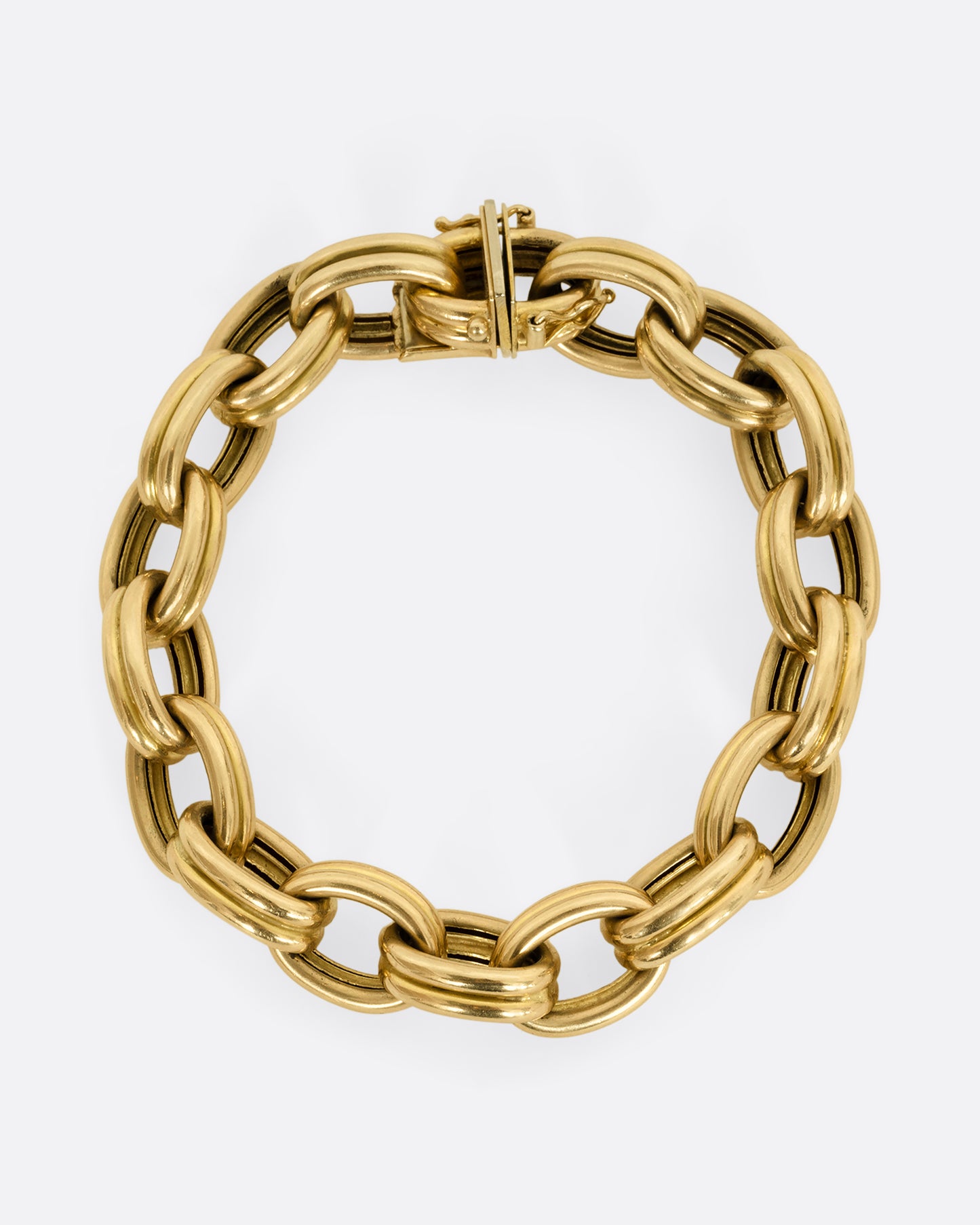 A yellow gold bracelet with double oval links. Shown closed, from above.