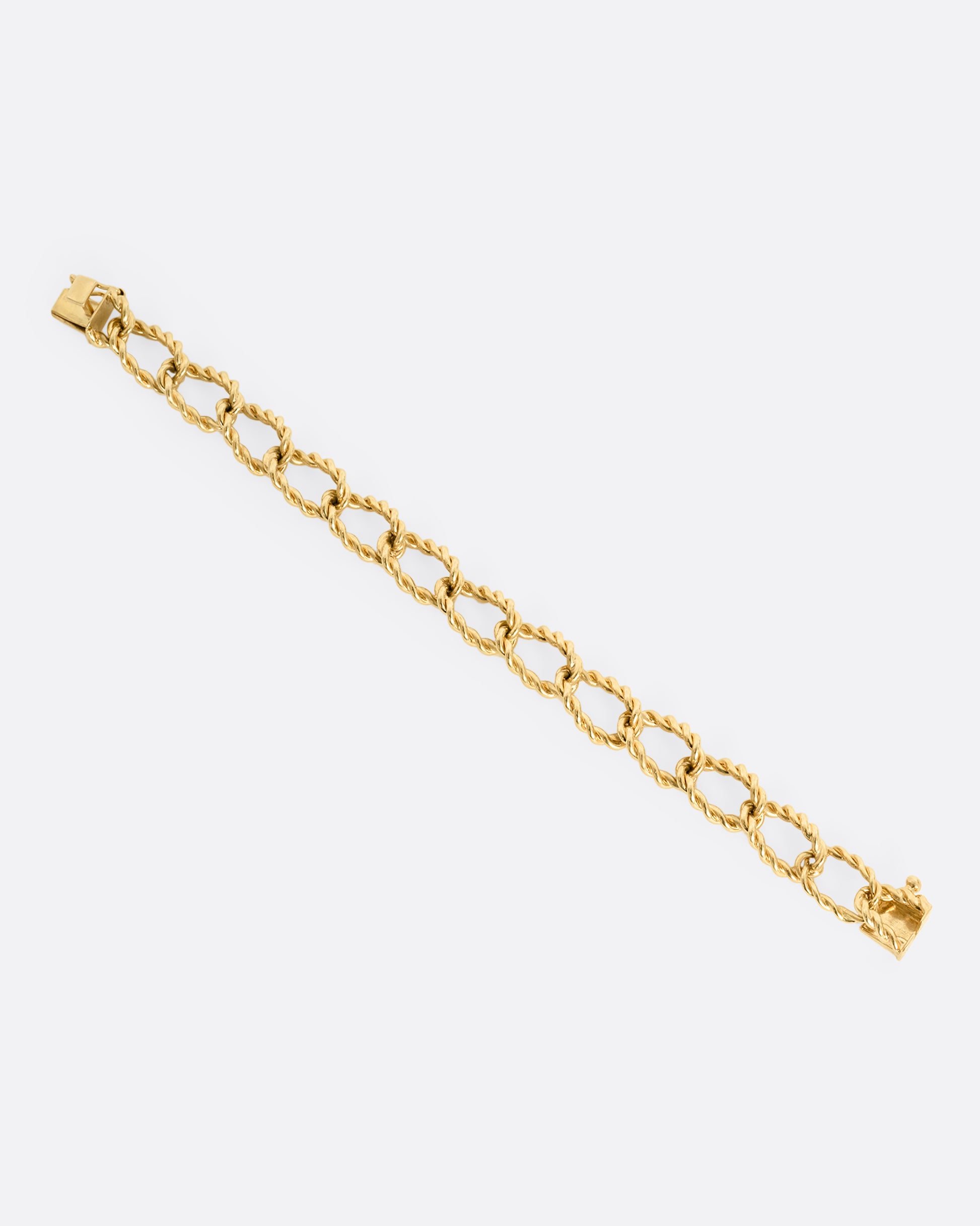 A yellow gold twisted link bracelet. Shown laying flat.