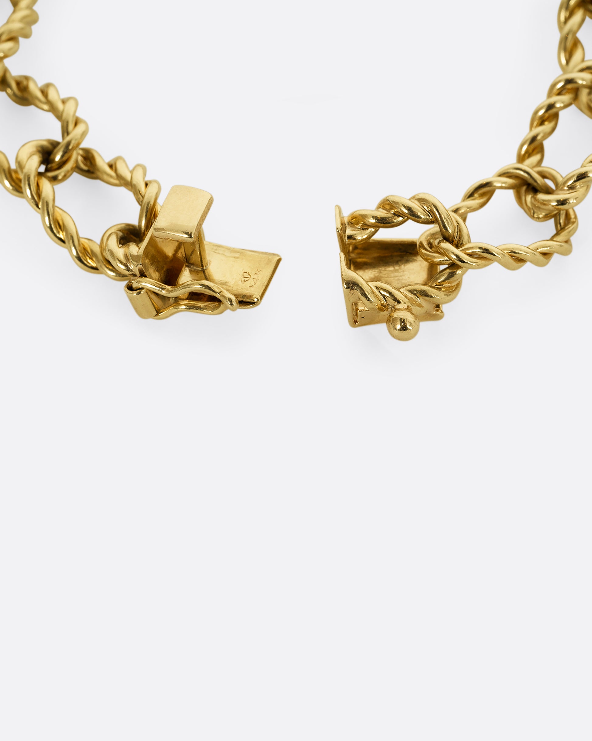 A yellow gold twisted link bracelet. Close up of clasp.