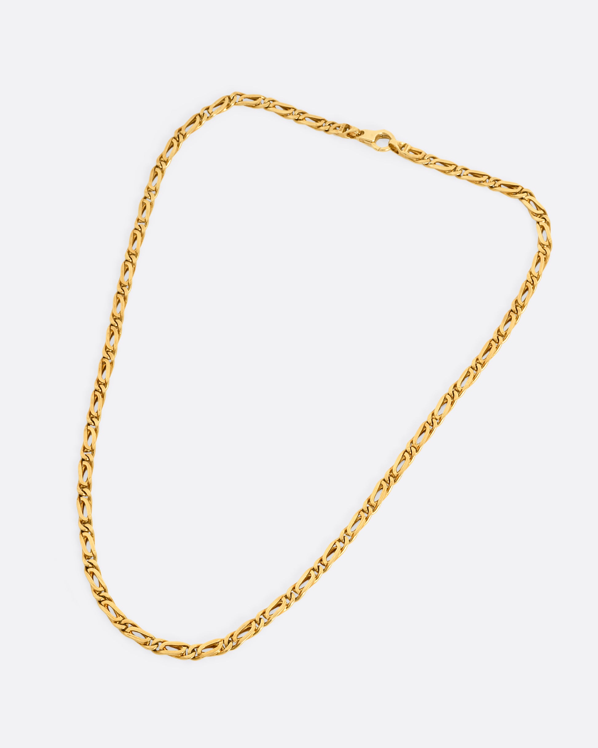 A yellow gold infinity chain link necklace. Shown laying flat.