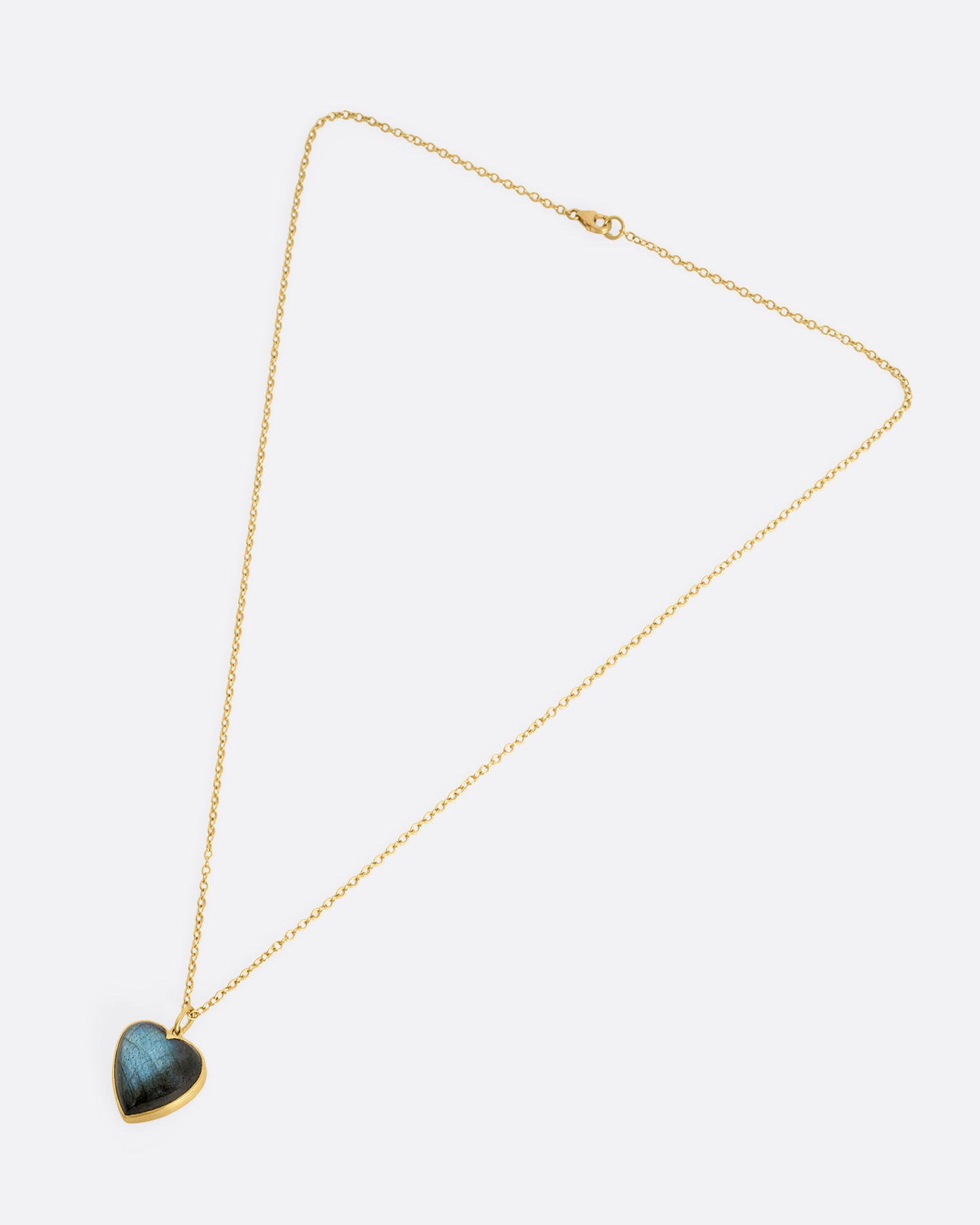 yellow gold necklace with a labradorite heart pendant shown from above