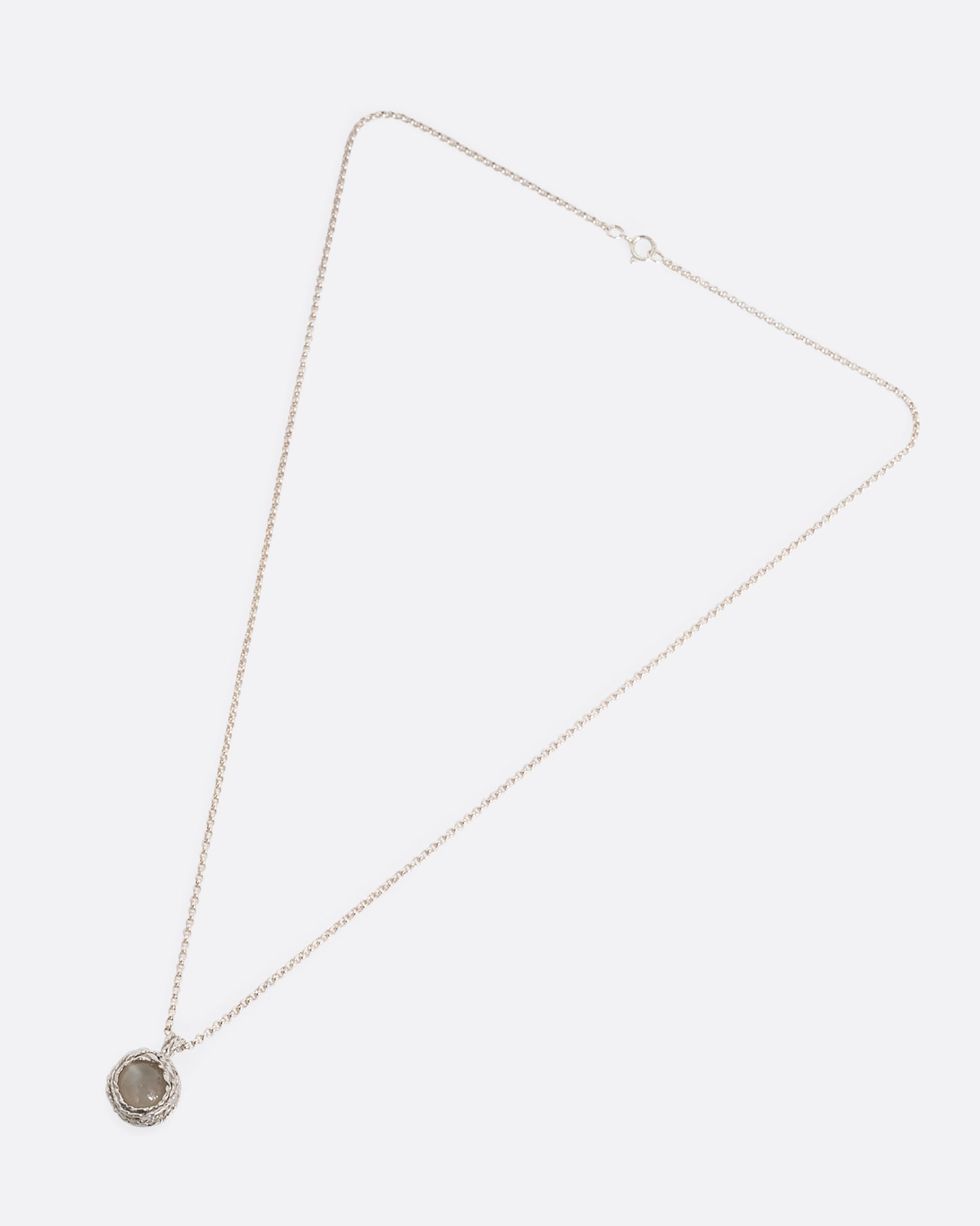 yellow gold necklace with navette shaped garnt shown from afar