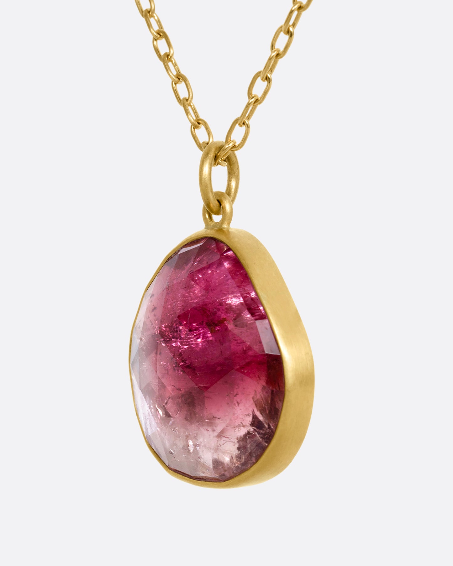 yellow gold necklace with an ombre pink tourmaline shown from the side