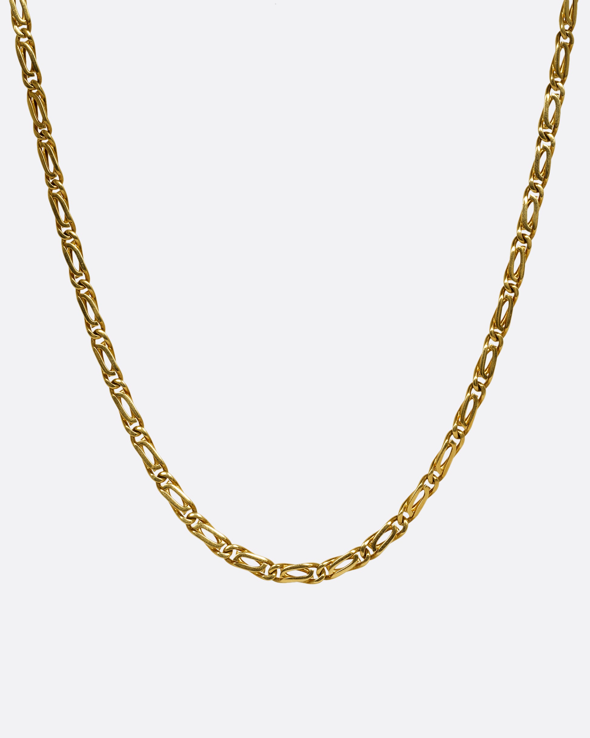 A yellow gold infinity chain link necklace. Shown from the front.