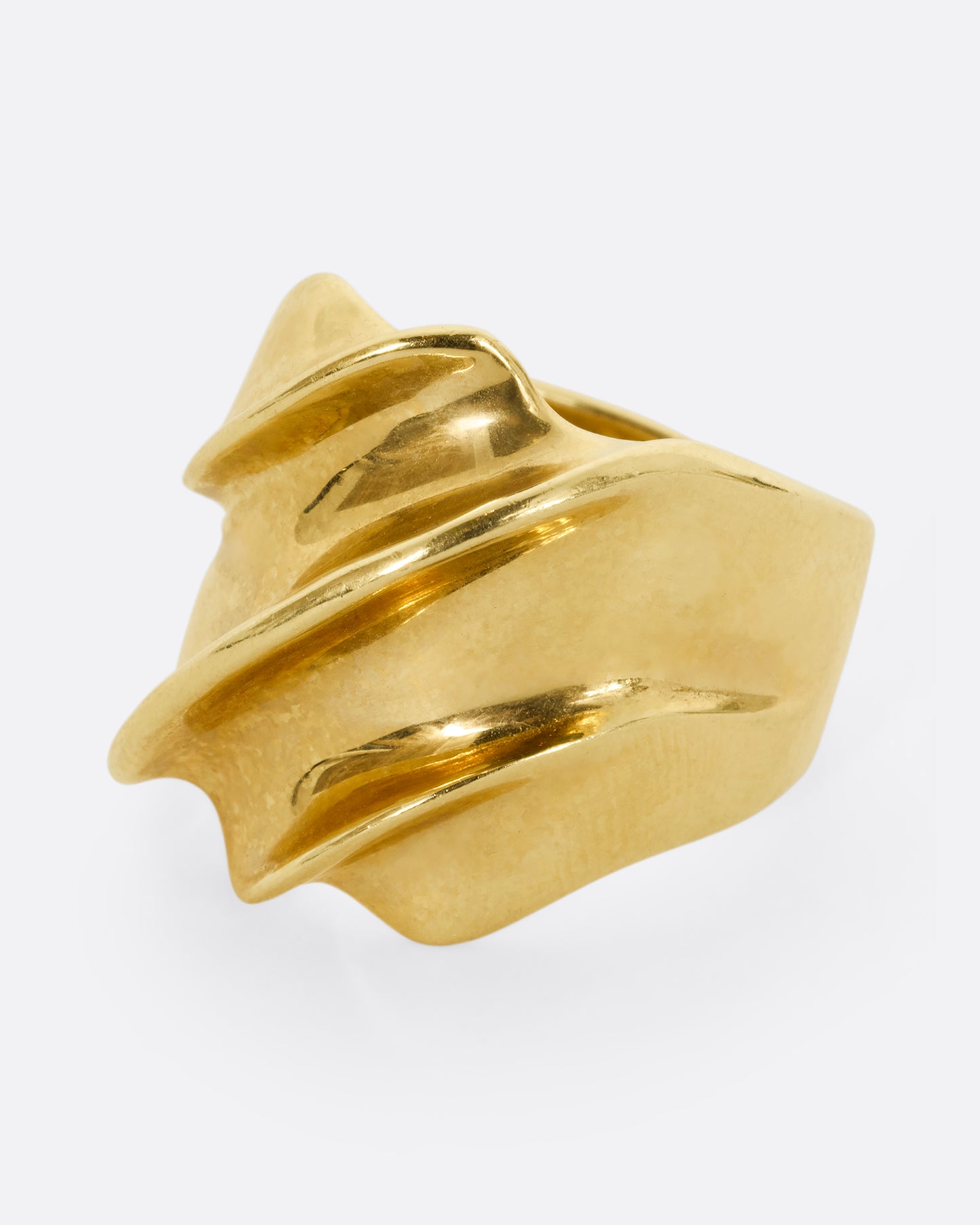 A chunky yellow gold wave ring. Shown from the side.