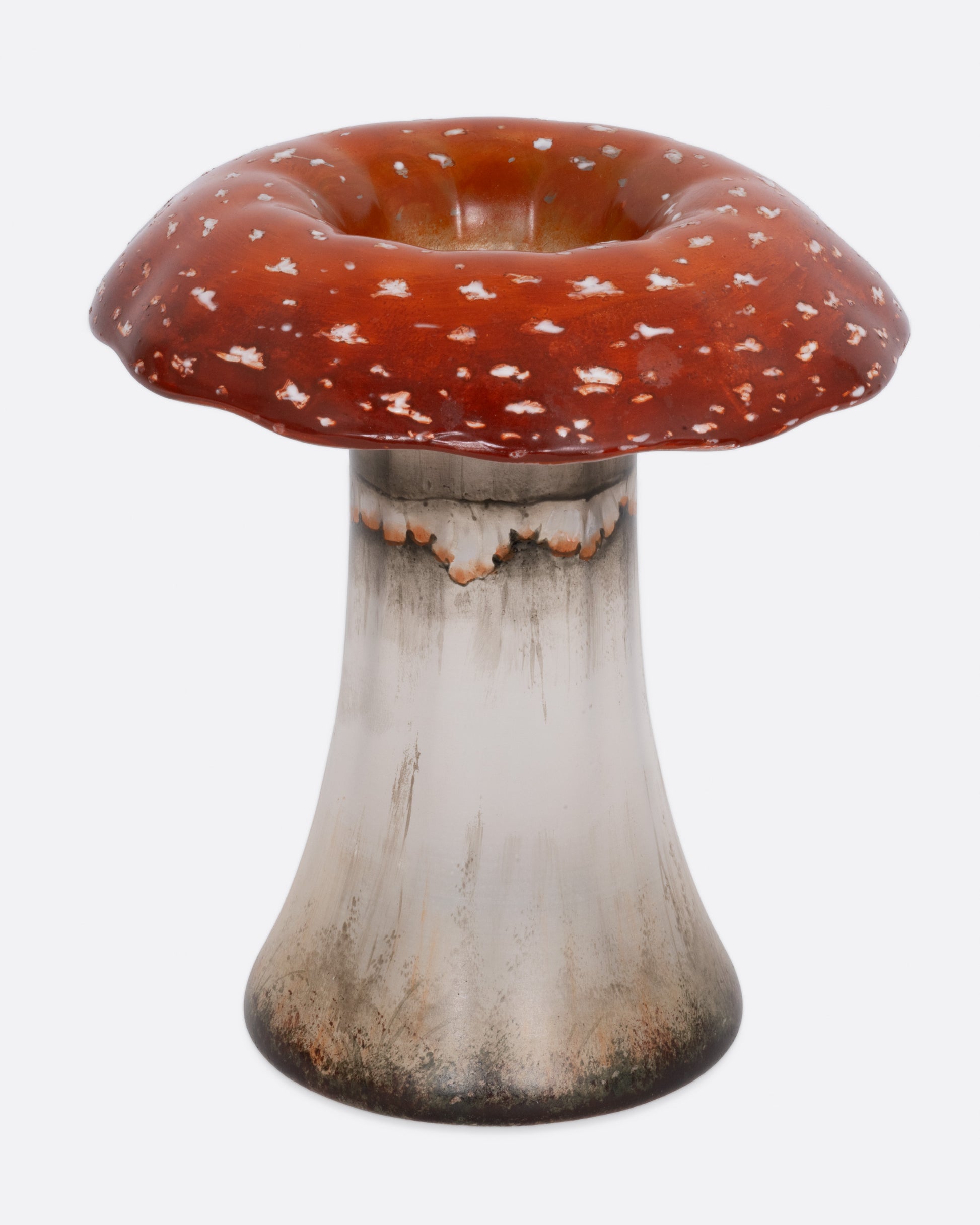 A hand painted red and white glass mushroom vase, shown from the front.
