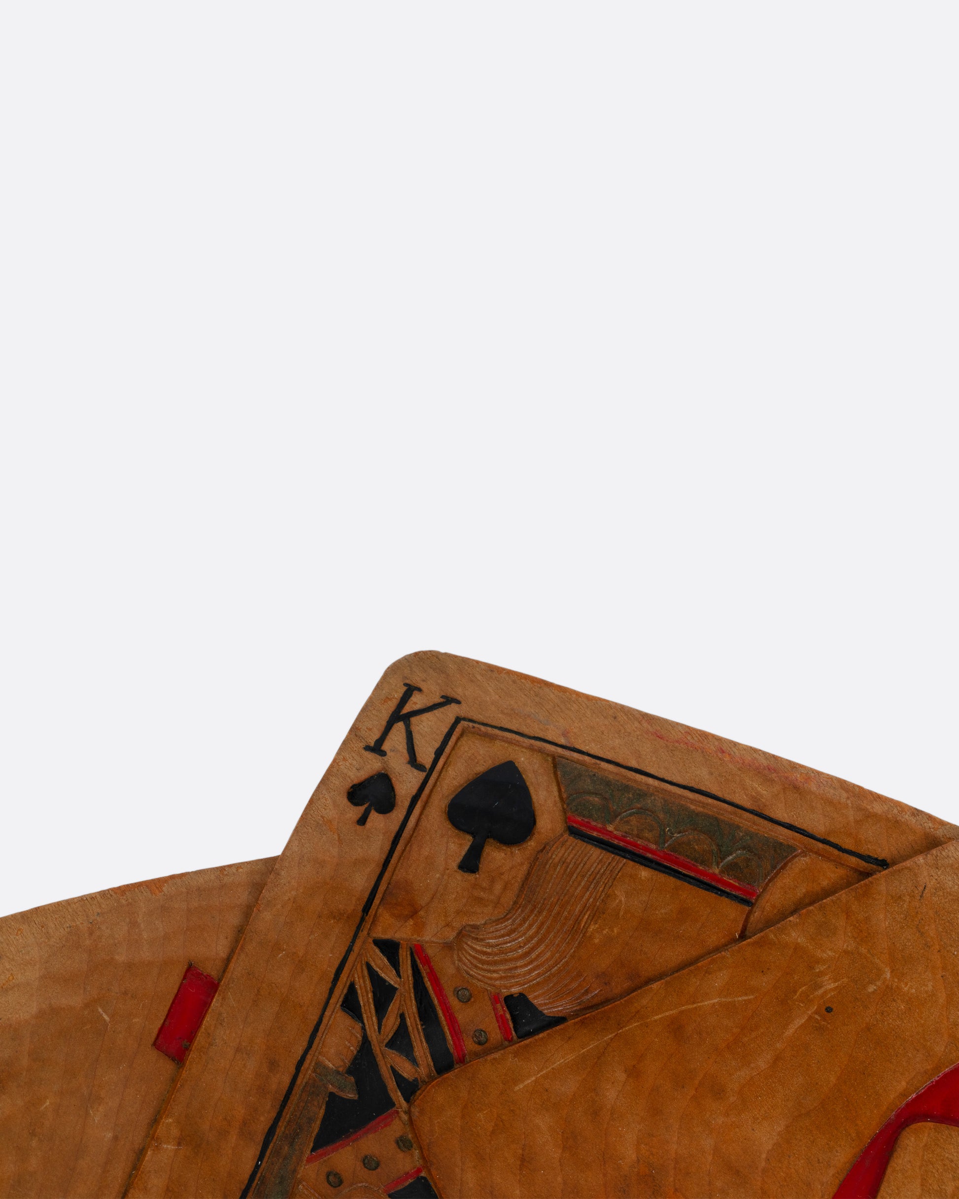 A close up of a hand carved wooden bowl in the shape of a star of playing cards. Shown from the top.