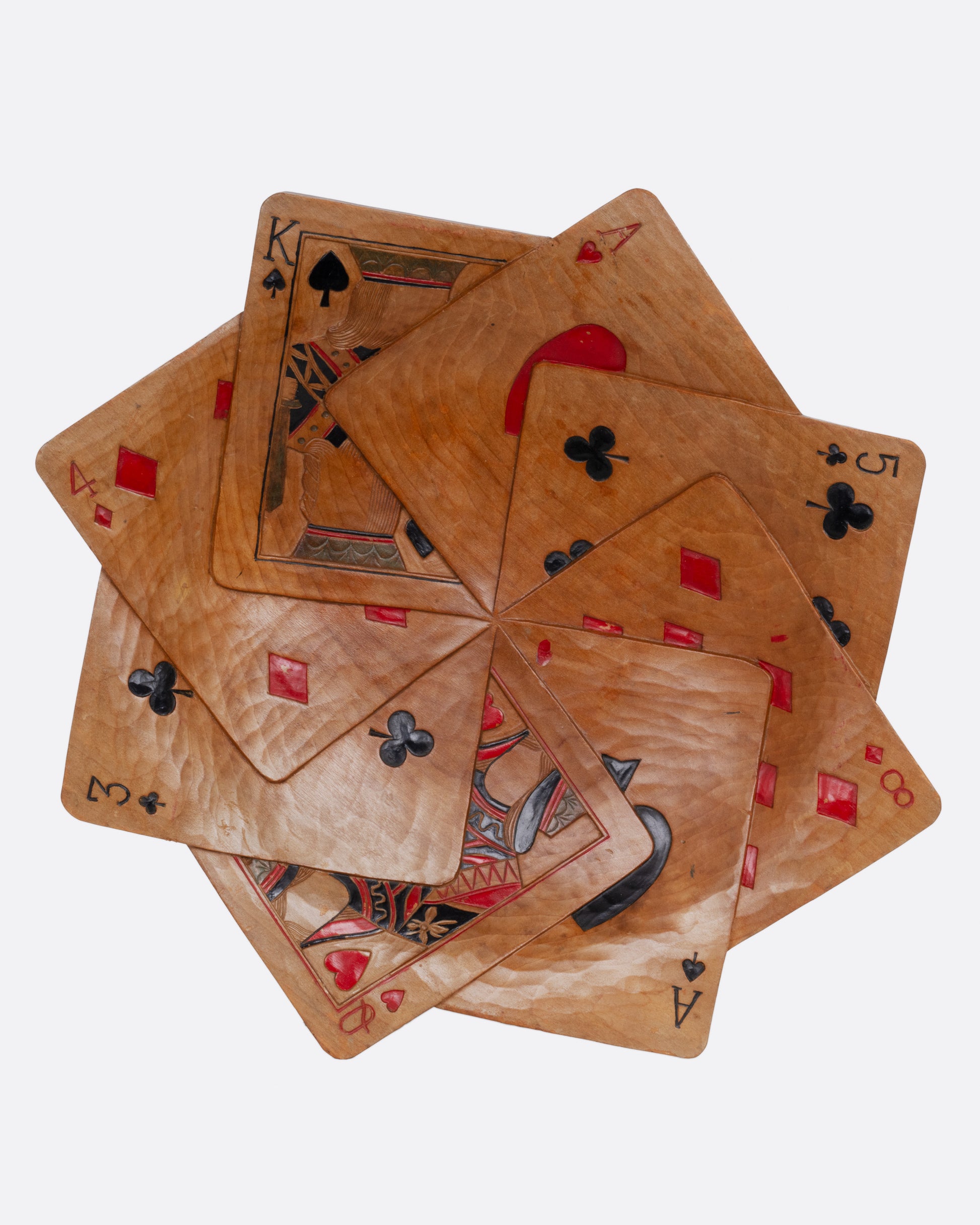 A hand carved wooden bowl in the shape of a star of playing cards. Shown from the top.