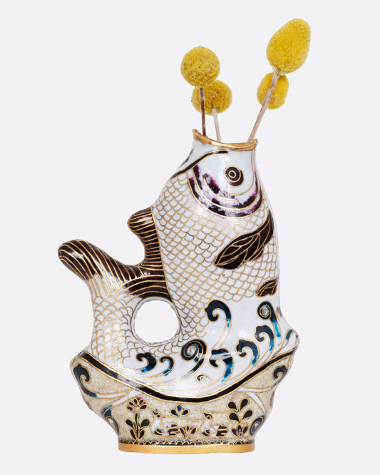 A  cloisonné fish vase, shown from the side with flowers in its open mouth.