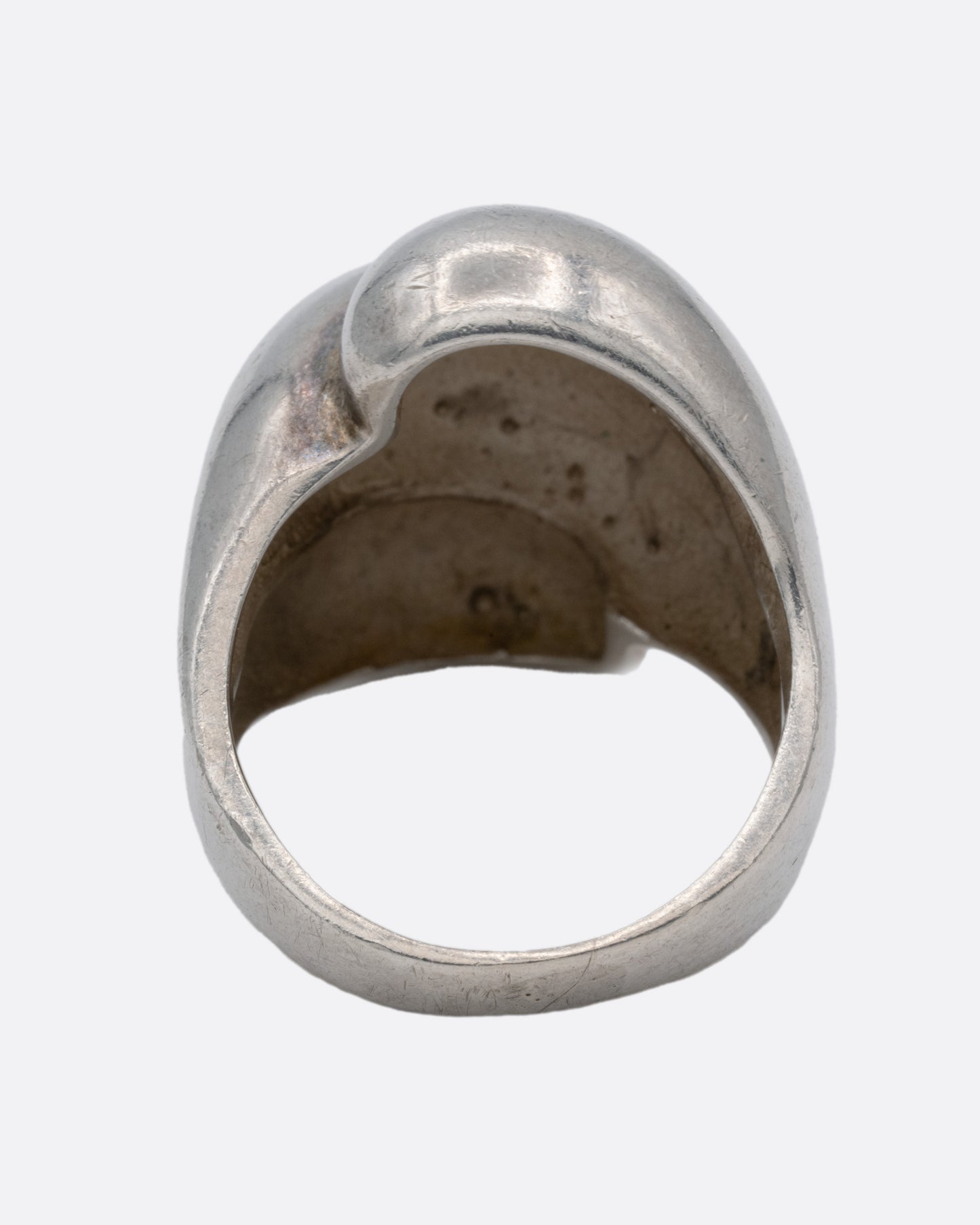 A silver ring with three domed tiers, shown from the back.