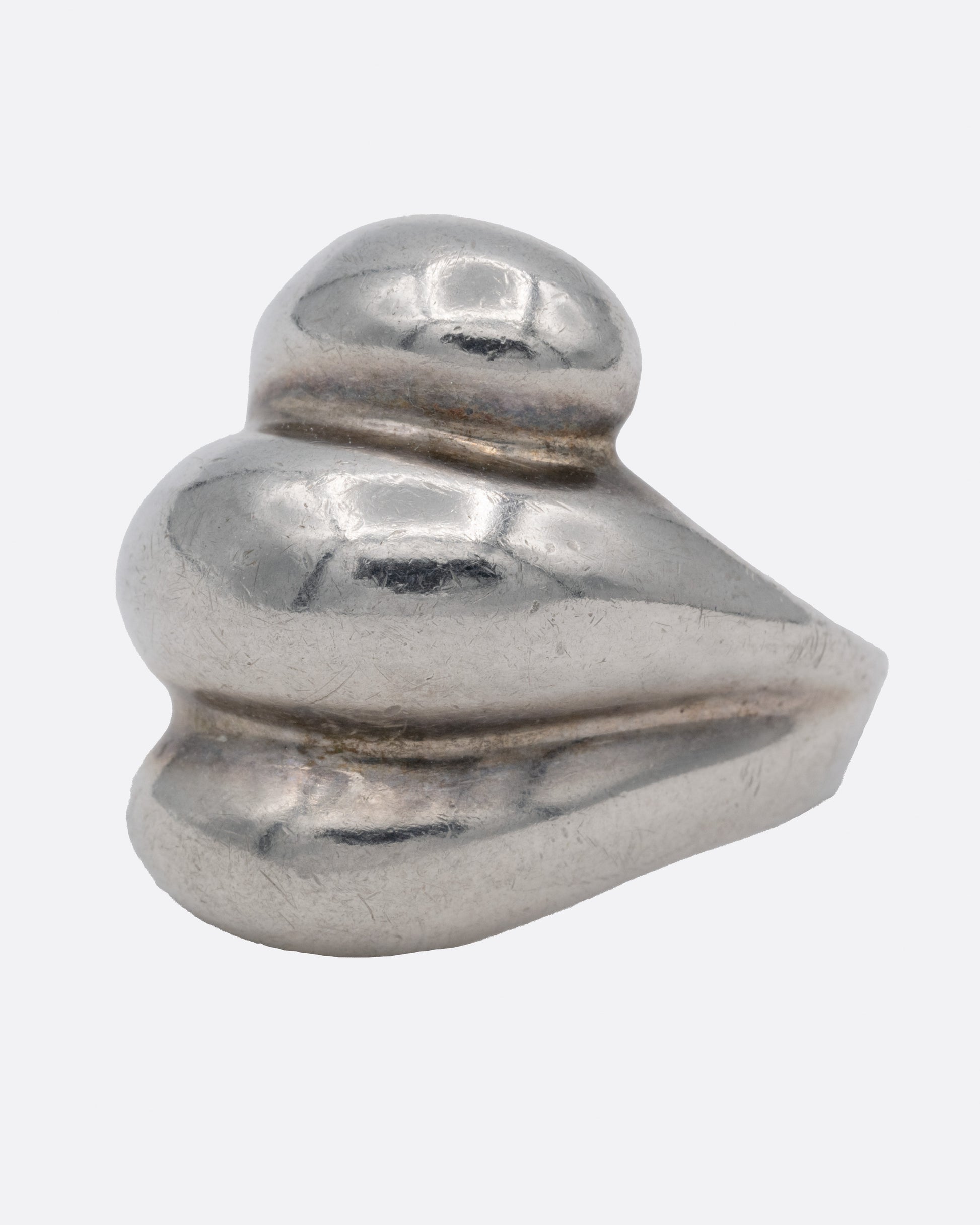 A silver ring with three domed tiers, shown from the side.