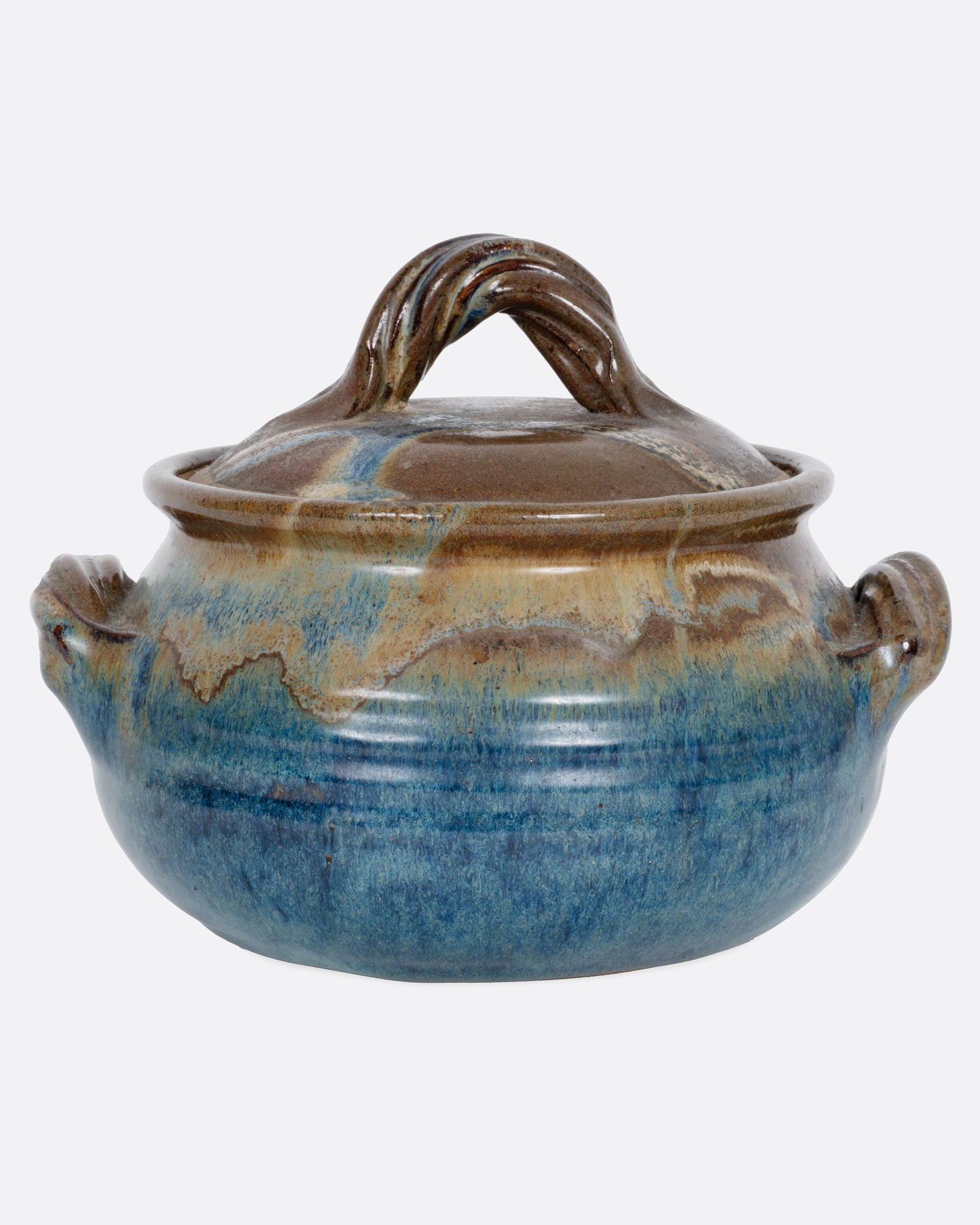 A ceramic pot with blue and brown glaze, dual handles, and a handled lid. Shown from the front.