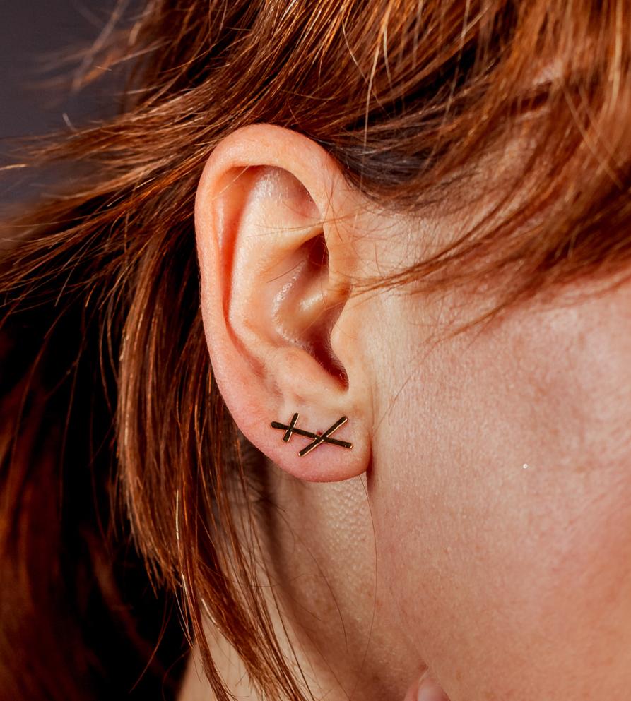 A single earring made from three strands of hammered, fairmined gold.