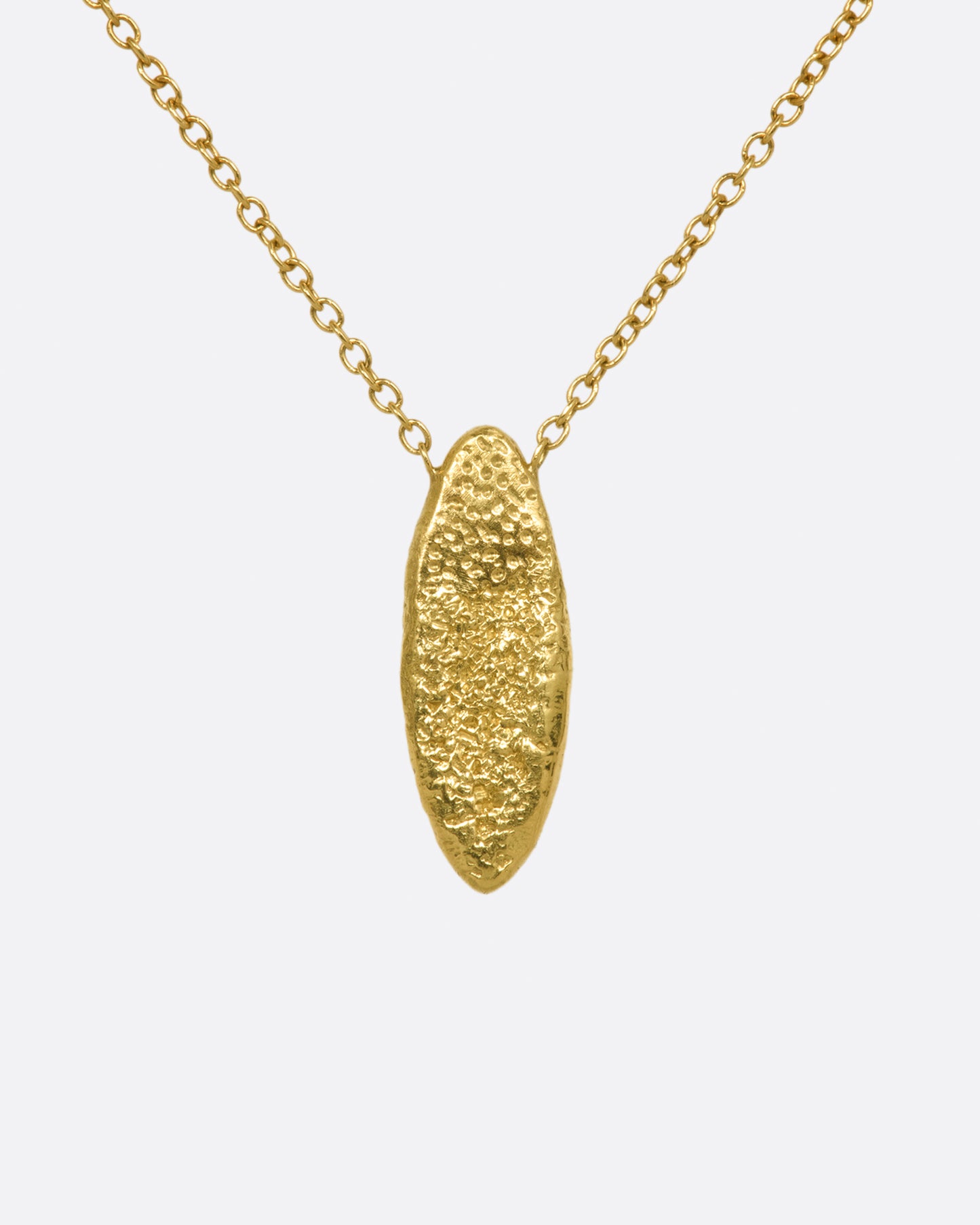 A yellow gold chain necklace with a marquise shape textured pendant, with two rows of red and brown diamonds. Shown from the back.