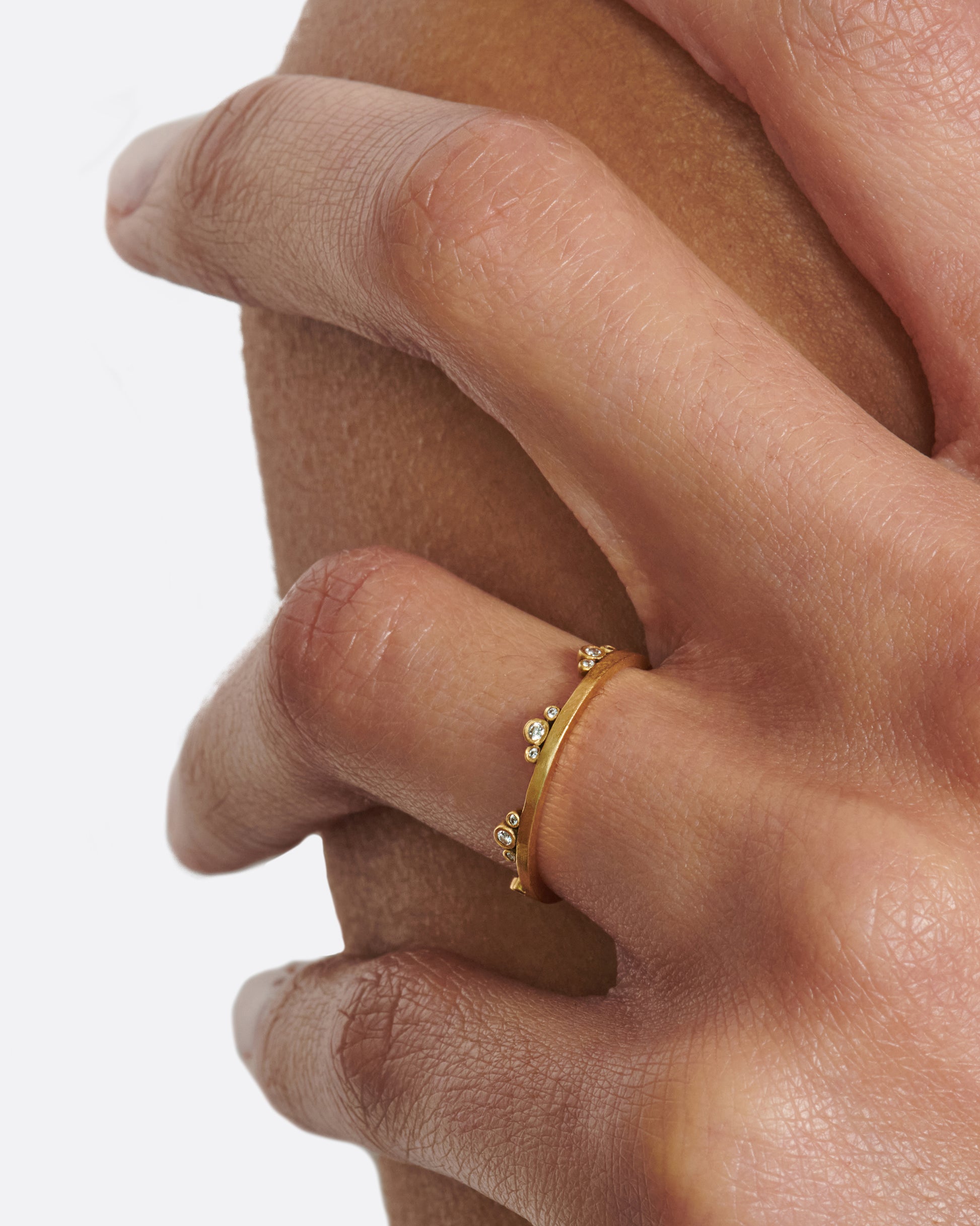 A matte gold band crowned with seven trios of diamonds.