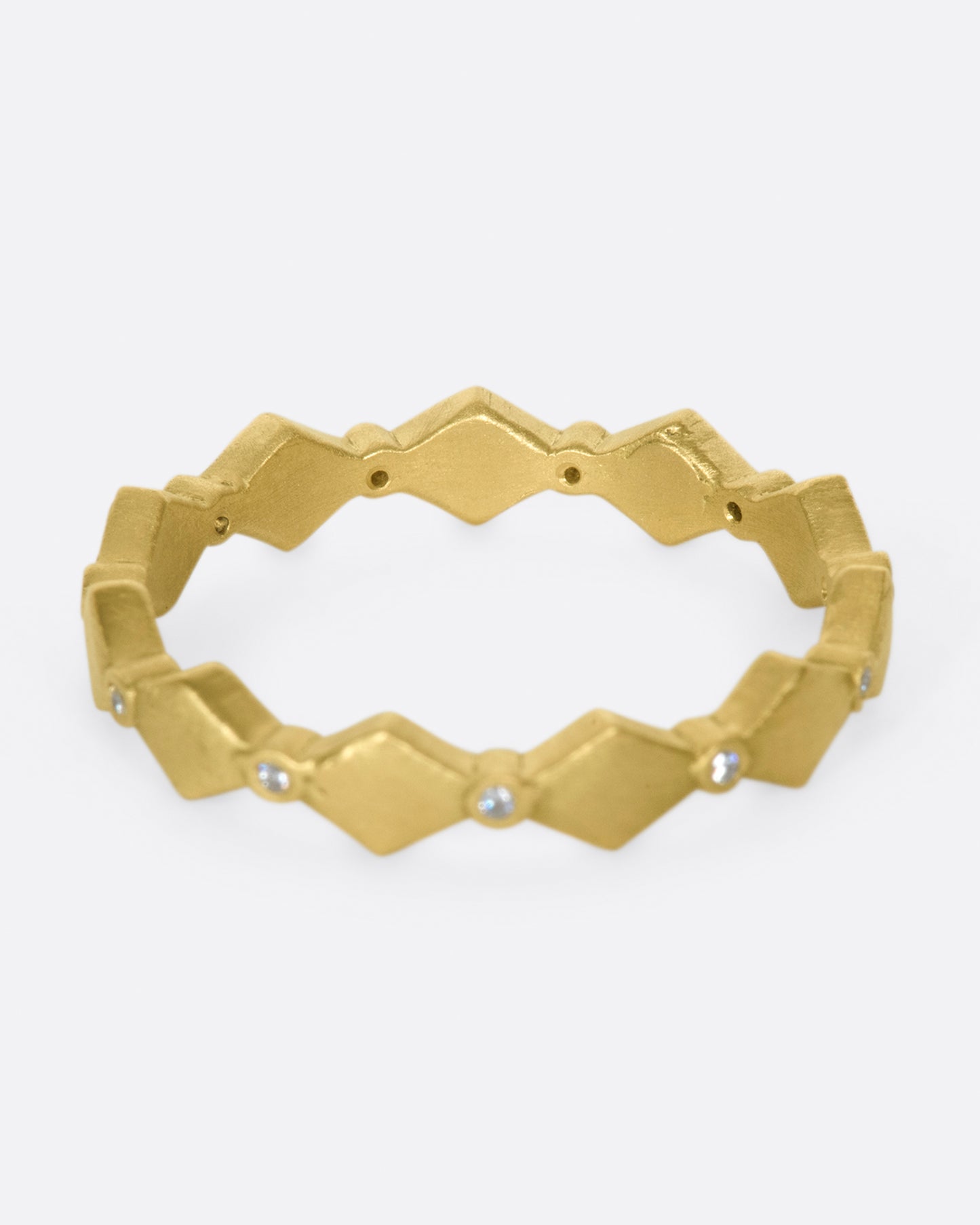 A geometric band with alternating round diamonds and matte gold shapes.