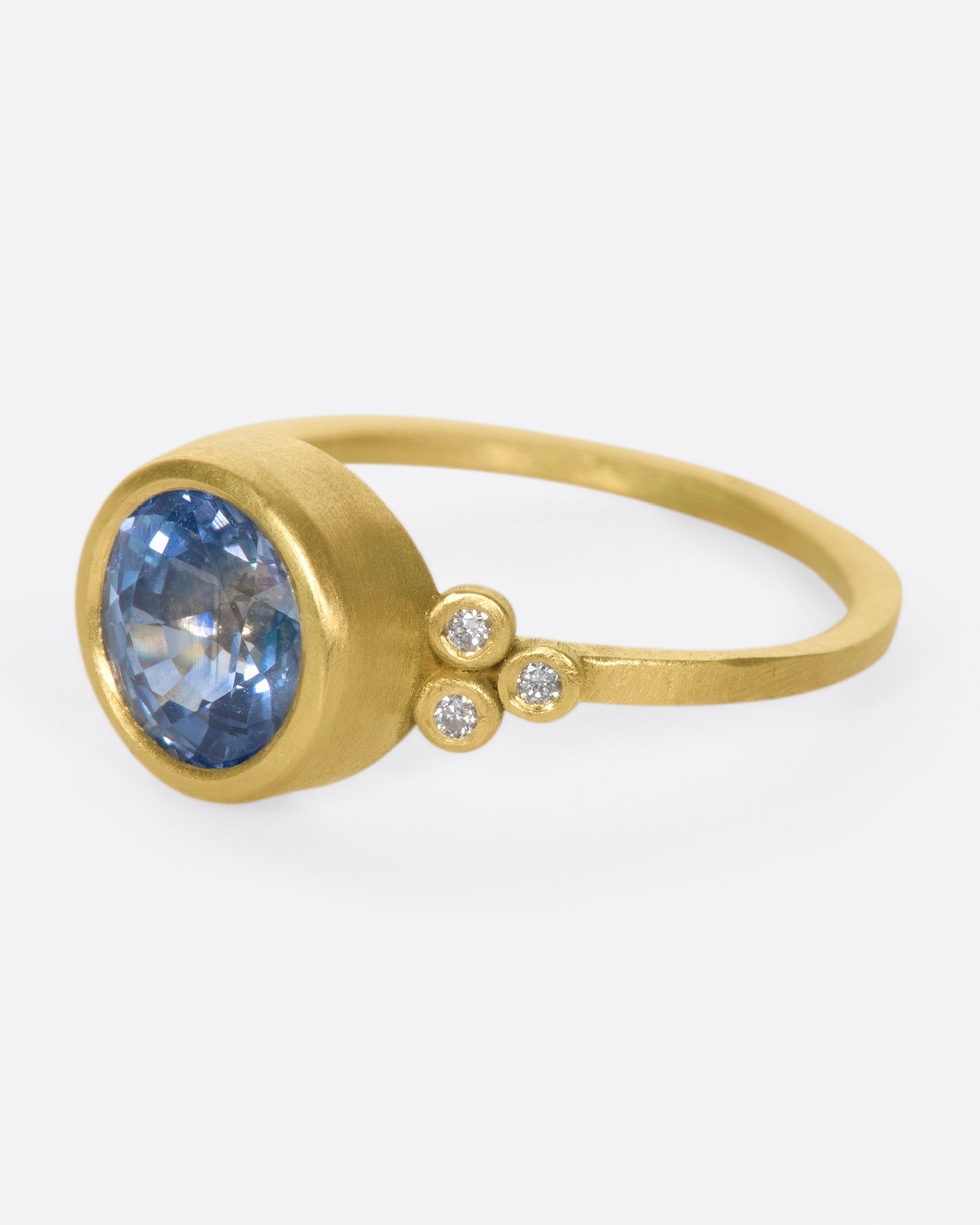 The stunning, periwinkle blue sapphire at the center of this ring is the star of the show.