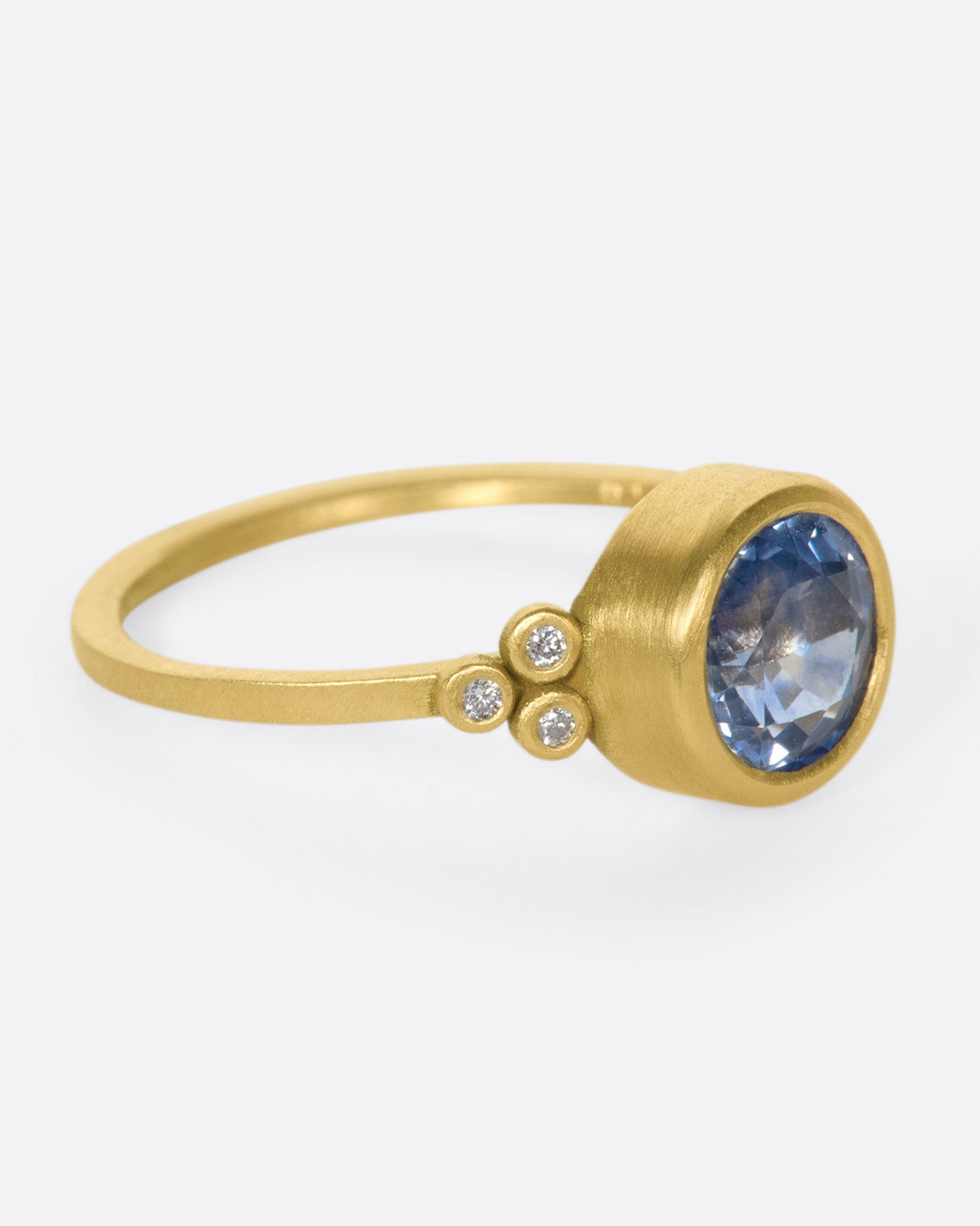 The stunning, periwinkle blue sapphire at the center of this ring is the star of the show.