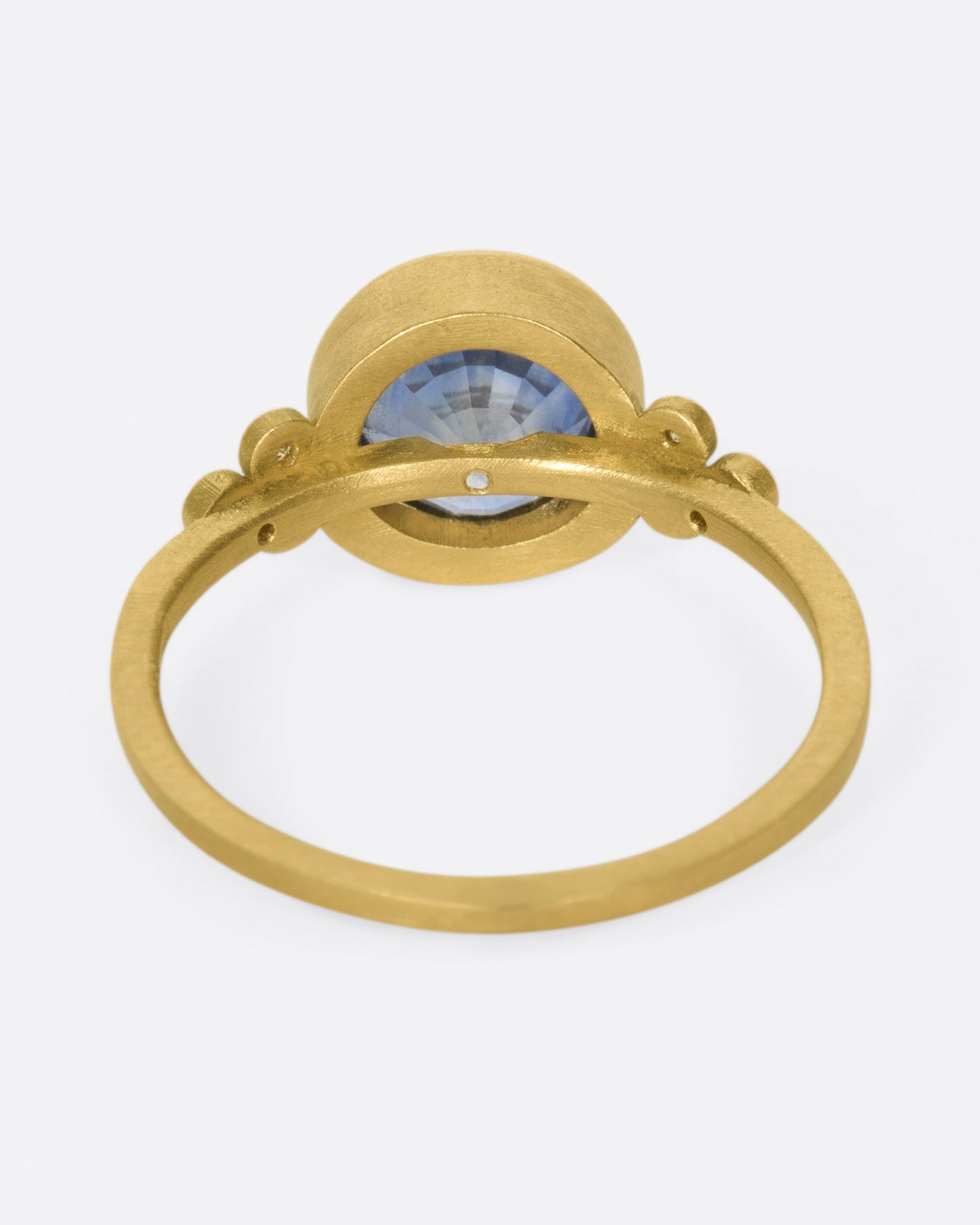 The stunning, periwinkle blue sapphire at the center of this ring is the star of the show.