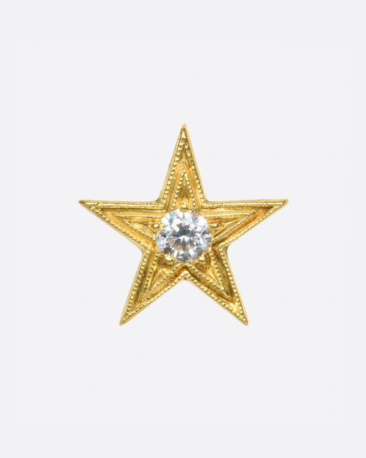 This earring is one of the many varieties of stars in Anthony Lent's work, this time a bit larger and more traditional.