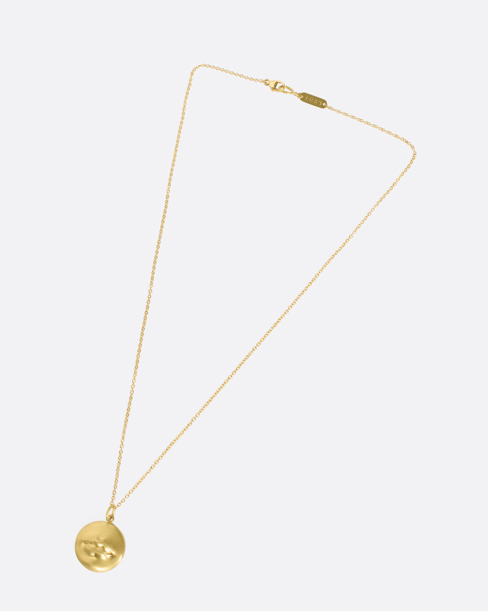 A solid, heavy pendant with a striking, sensual design with a sense of humor.