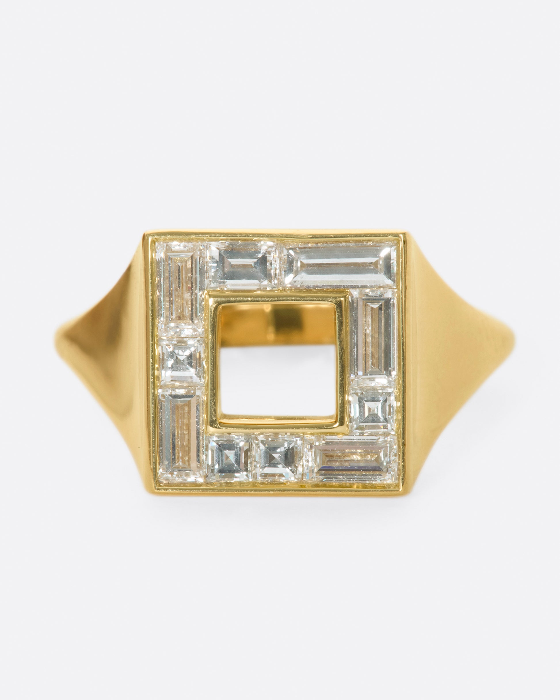 A photo of a square ring set with baguette diamonds.