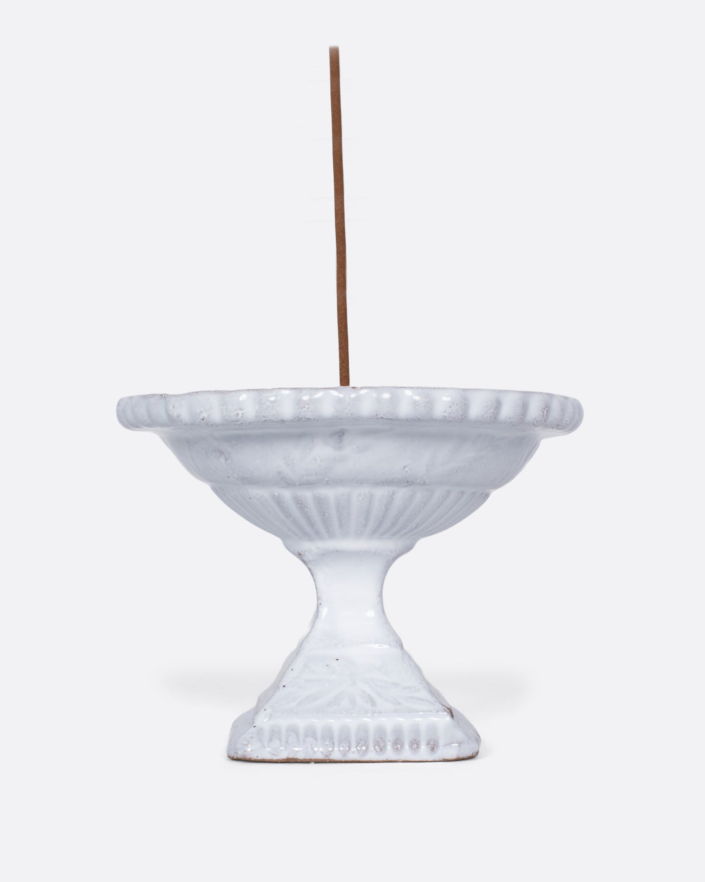 A handmade porcelain incense holder with a shiny white glaze. It looks like a Roman fountain, crafted for life in miniature, with a French-cool feel.