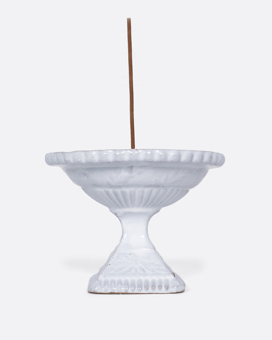 A handmade porcelain incense holder with a shiny white glaze. It looks like a Roman fountain, crafted for life in miniature, with a French-cool feel.