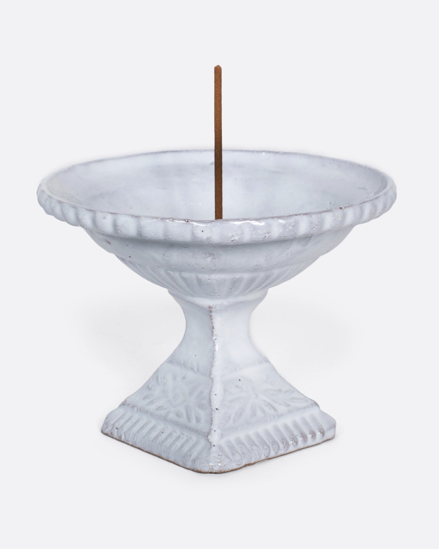 A handmade porcelain incense holder with a shiny white glaze. It looks like a Roman fountain, crafted for life in miniature, with a French-cool feel.