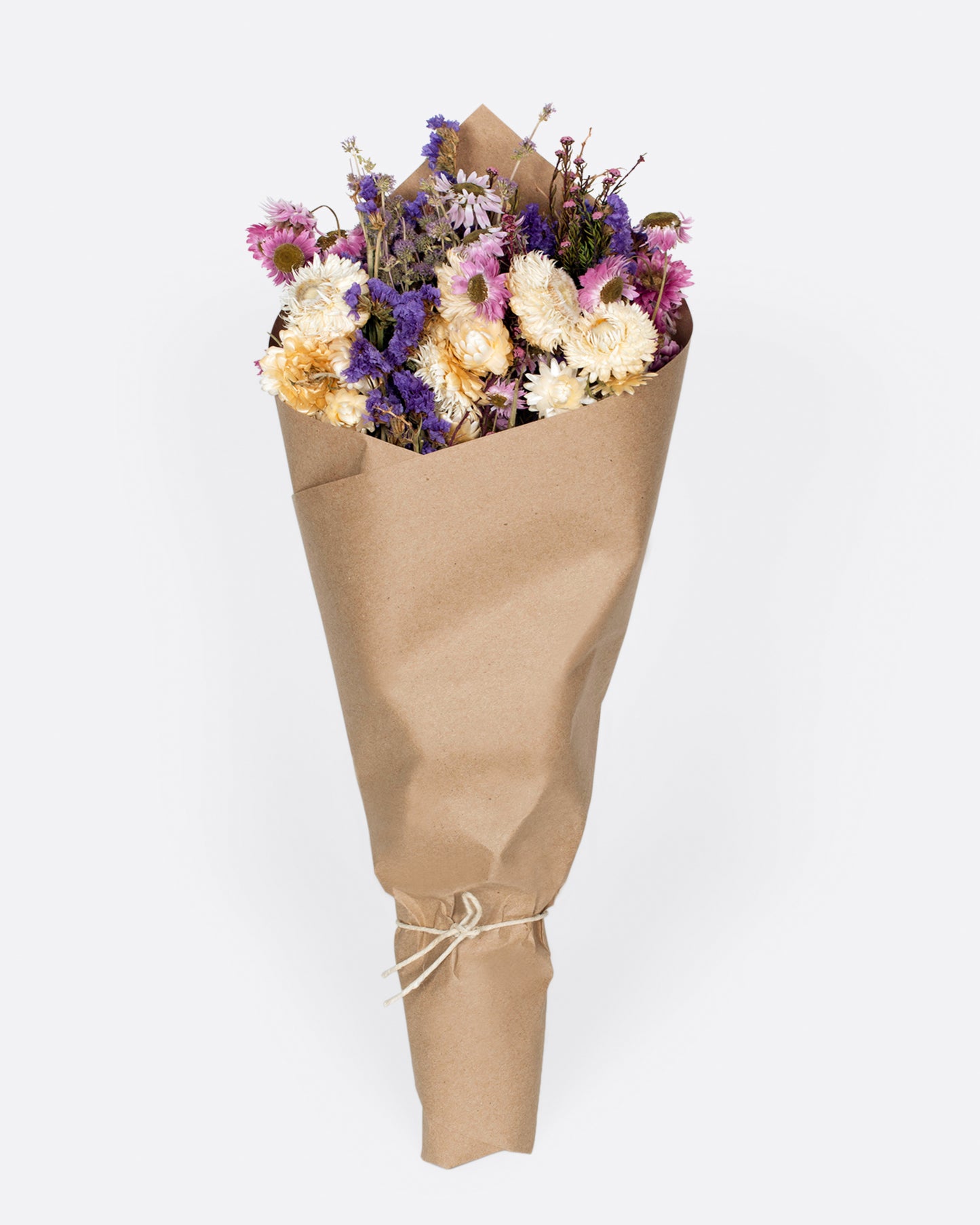 A handmade floral arrangement with purple, pink and white hues.