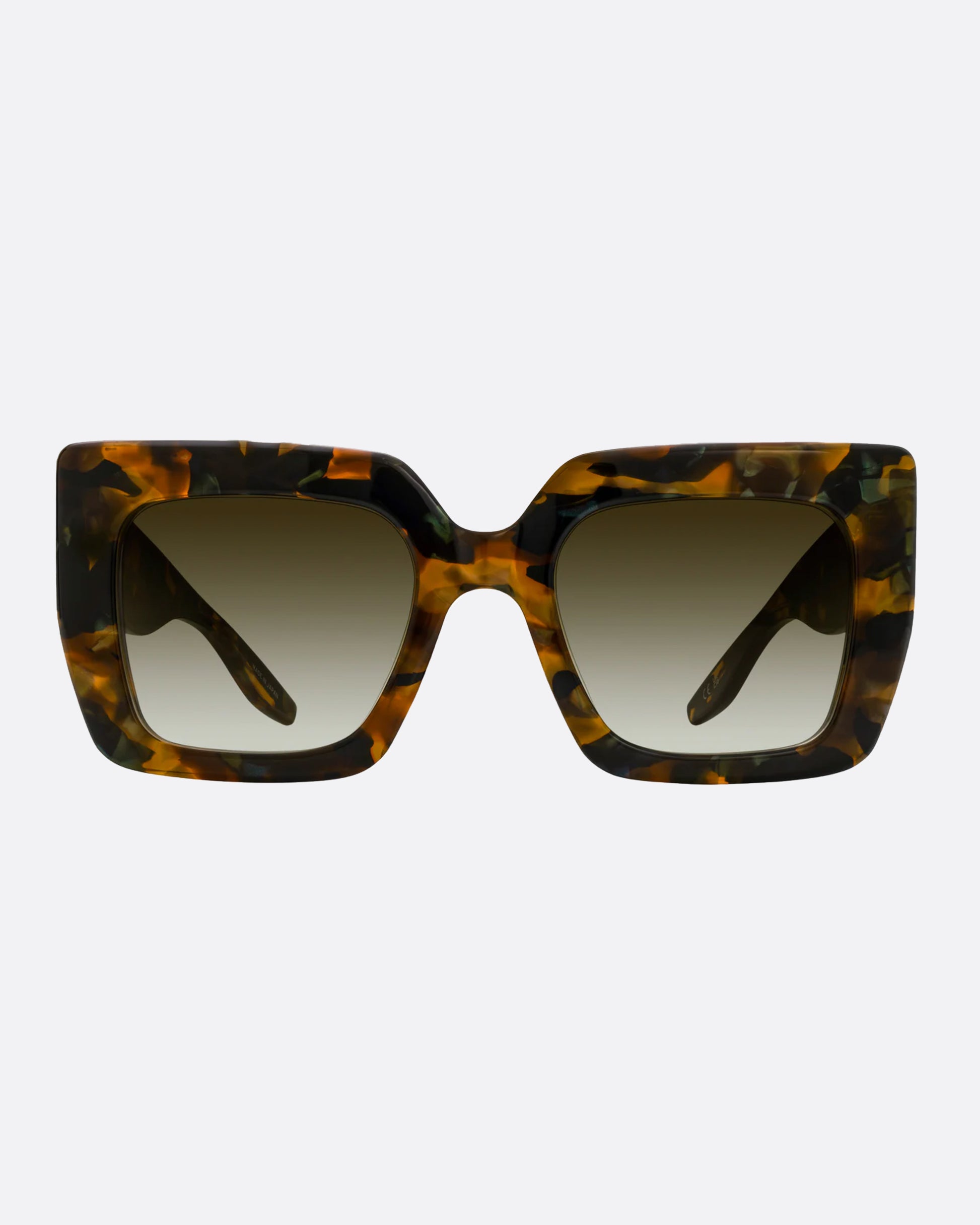 A pair of dark brown and green tortoise acetate cat eye sunglasses with green lenses.