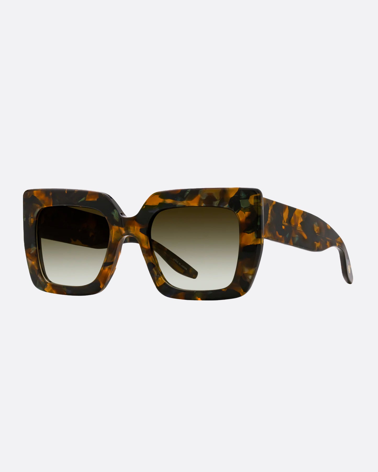 A pair of dark brown and green tortoise acetate cat eye sunglasses with green lenses. Shown from the side.