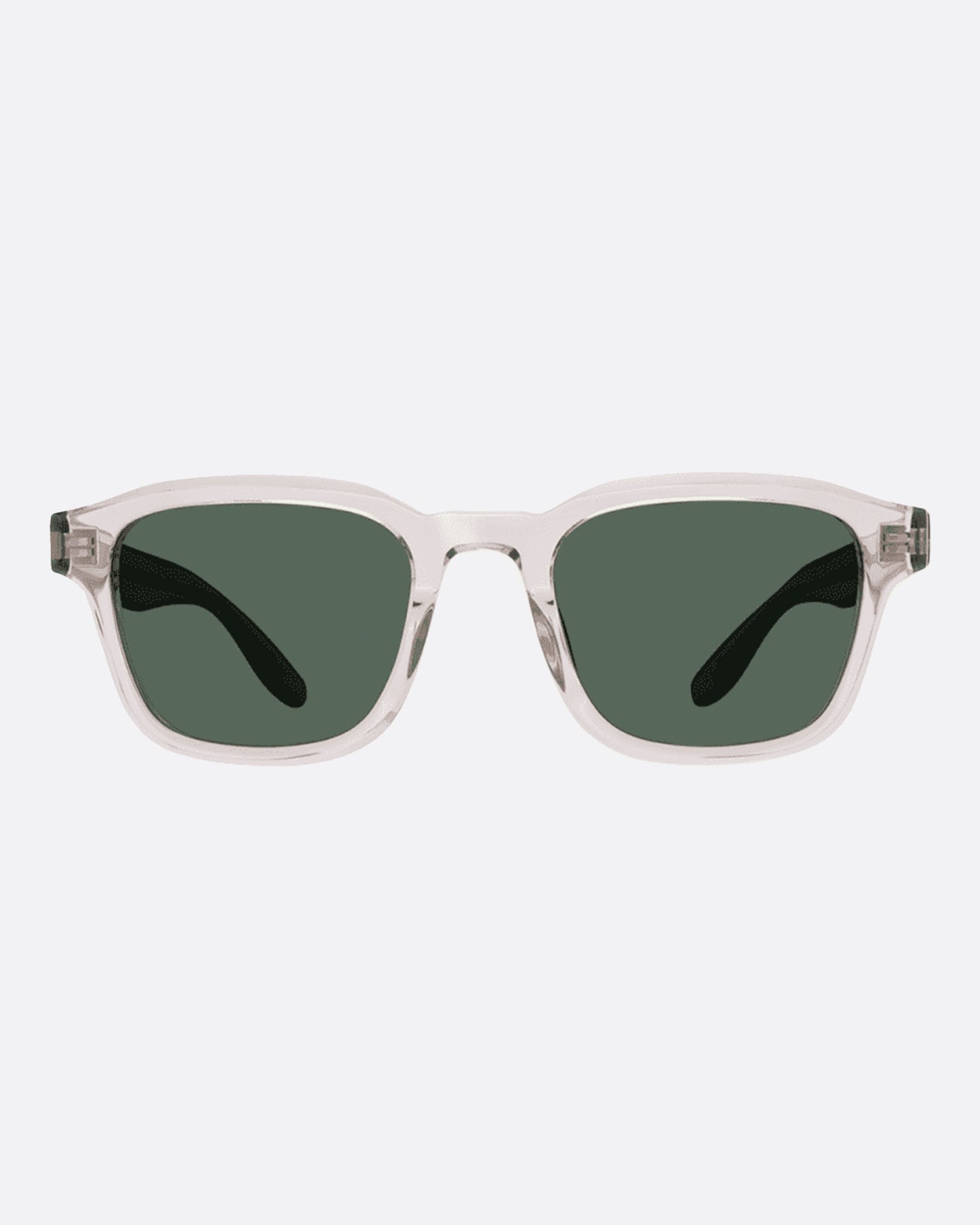 A pair of clear acetate wayfarer sunglasses with green lenses.