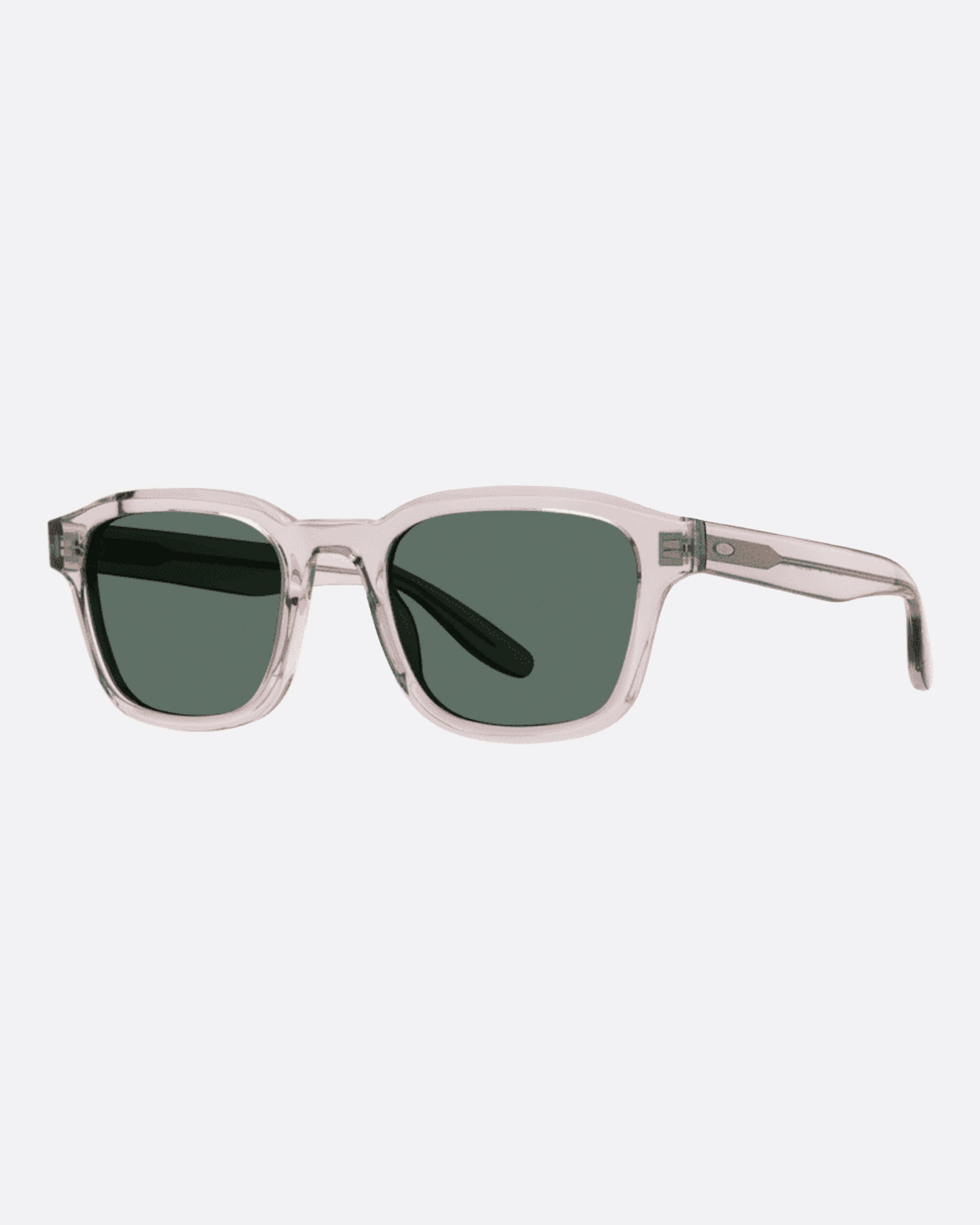 A pair of clear acetate wayfarer sunglasses with green lenses. Shown from the side.