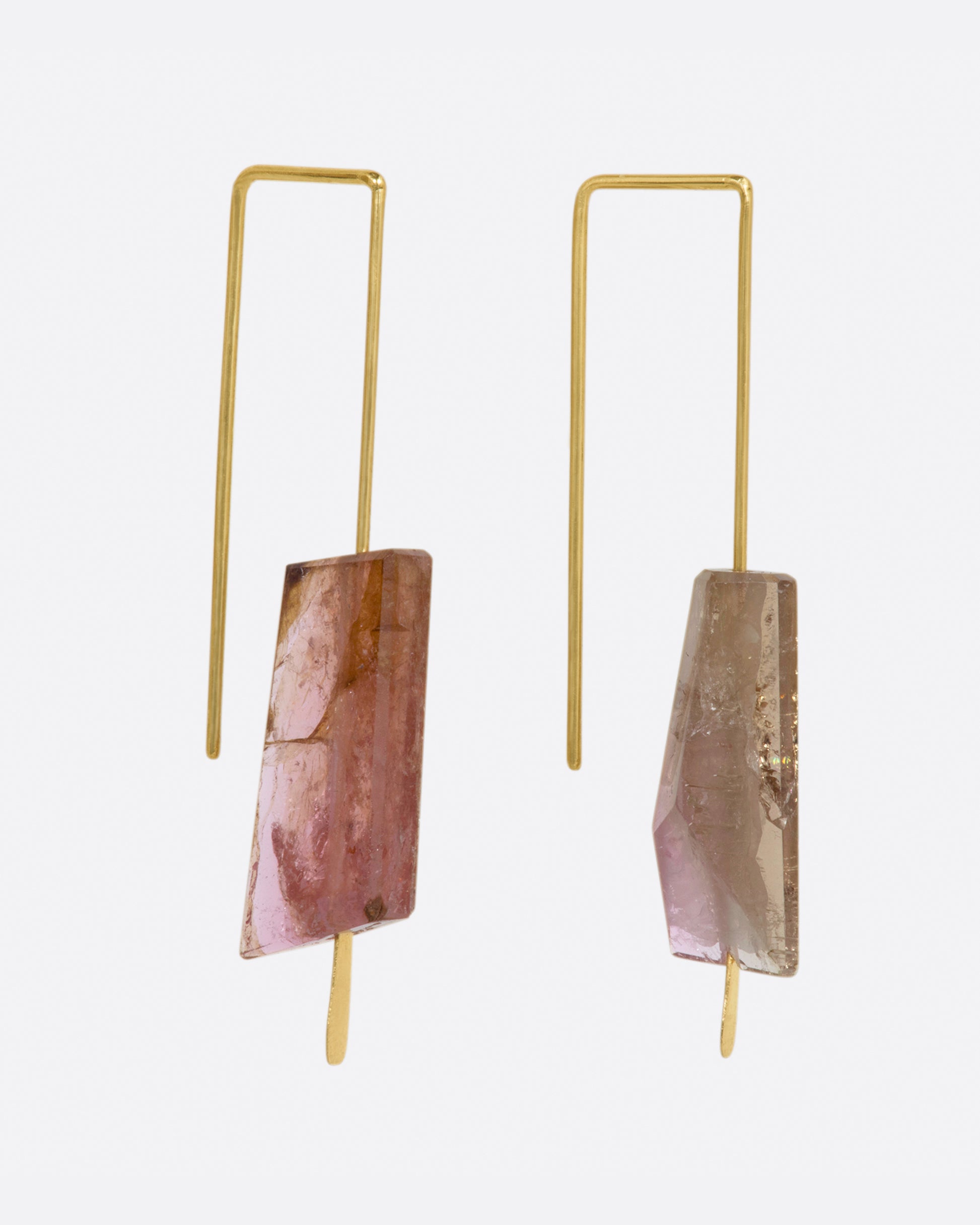 Yellow gold rectangular hook earrings with a single light pink tourmaline on each. View from the side.