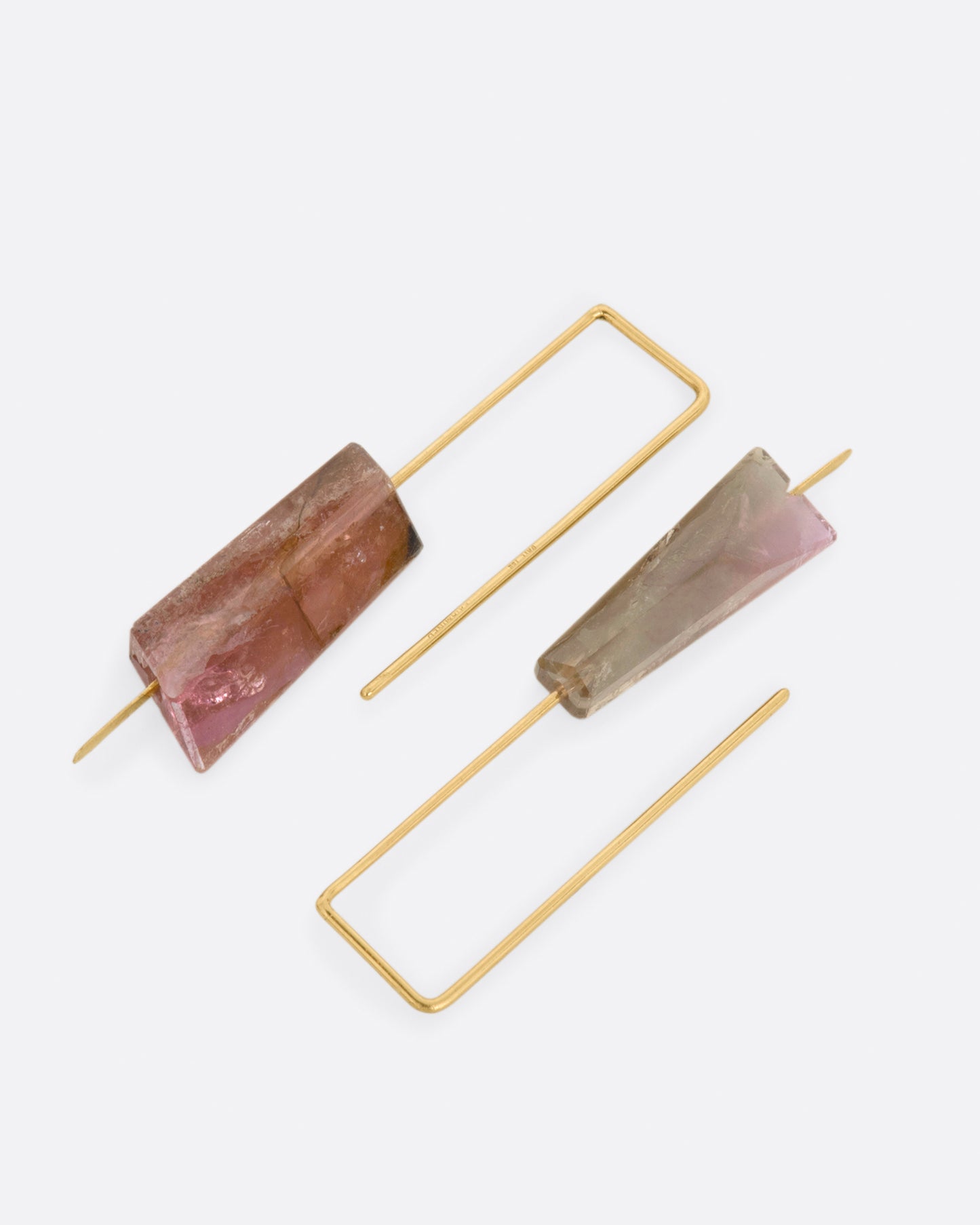 Yellow gold rectangular hook earrings with a single light pink tourmaline on each. View laying flat.