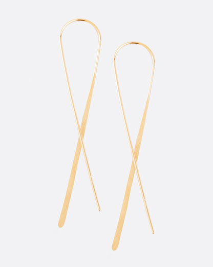 Christine Fail large crossed hook earrings in Fairmined gold, two long thin wires crossing in an X