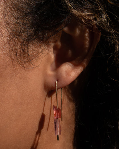 Christine Fail medium hook earring in Fairmined 14k yellow gold worn on an ear, two light pink tourmaline slices stacked on a long gold wire