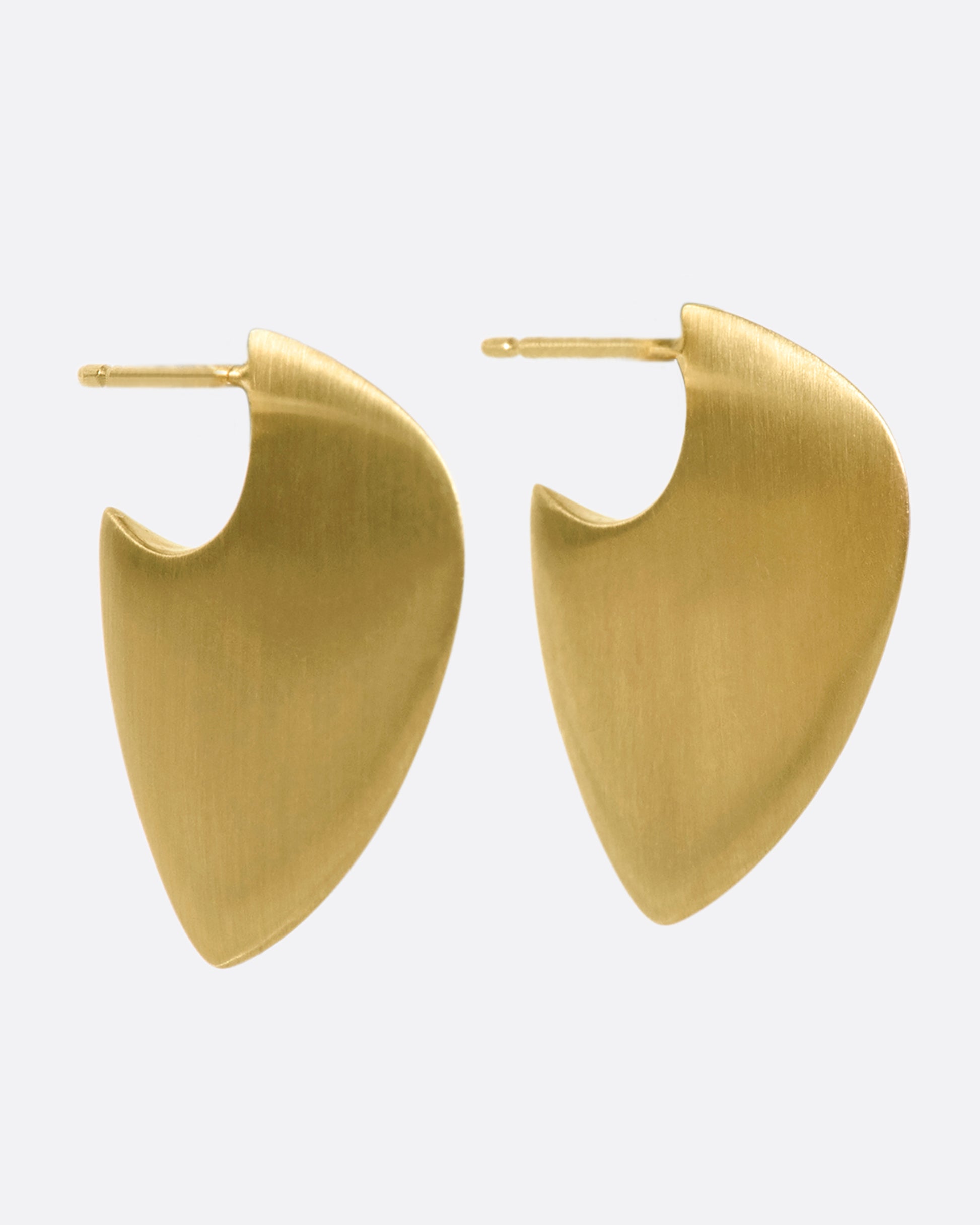 A pair of 10k solid gold hoop earrings with a guitar pick shape