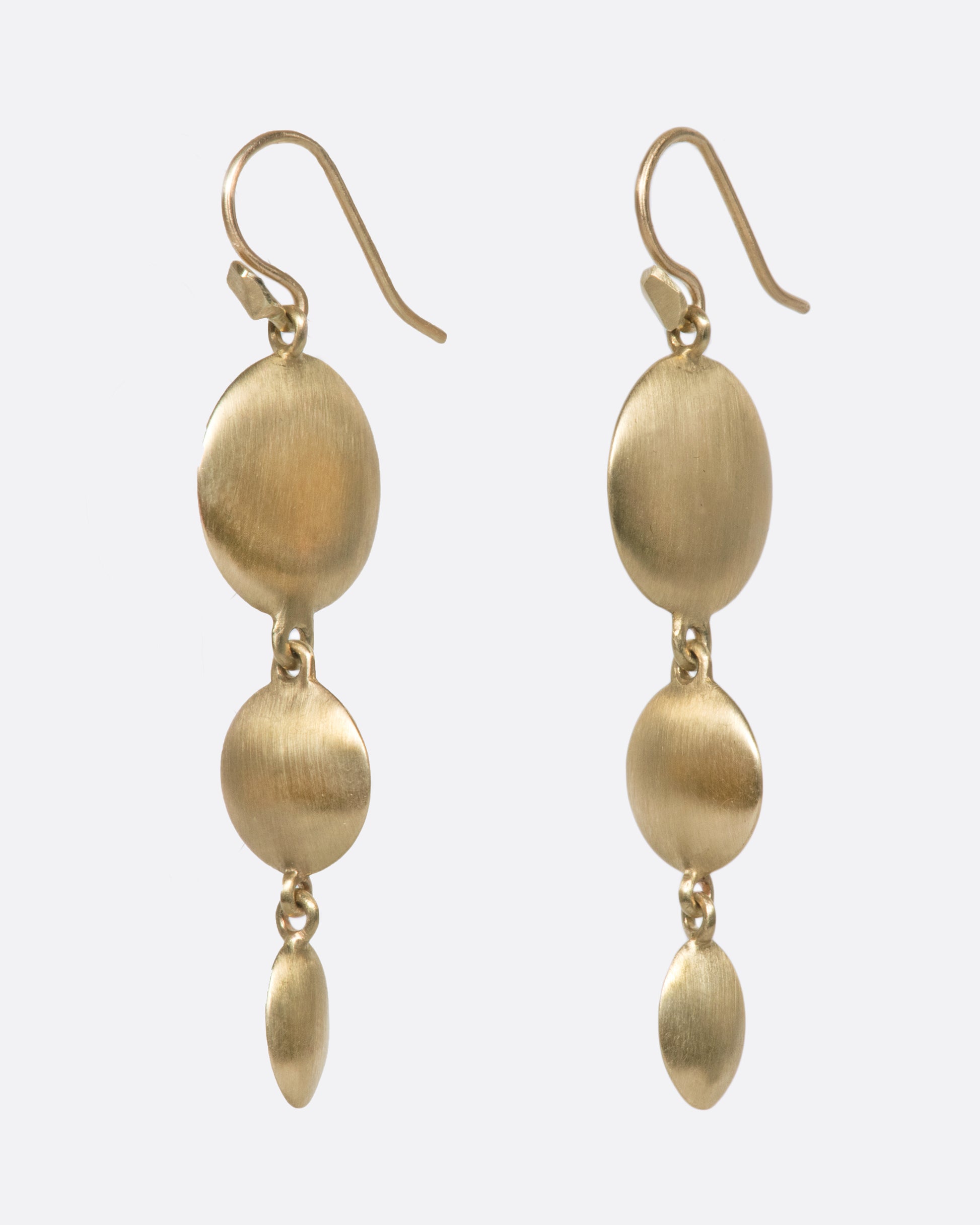 These unusual triple drop brushed gold earrings have impressive razor thin edges that make them look different from every angle