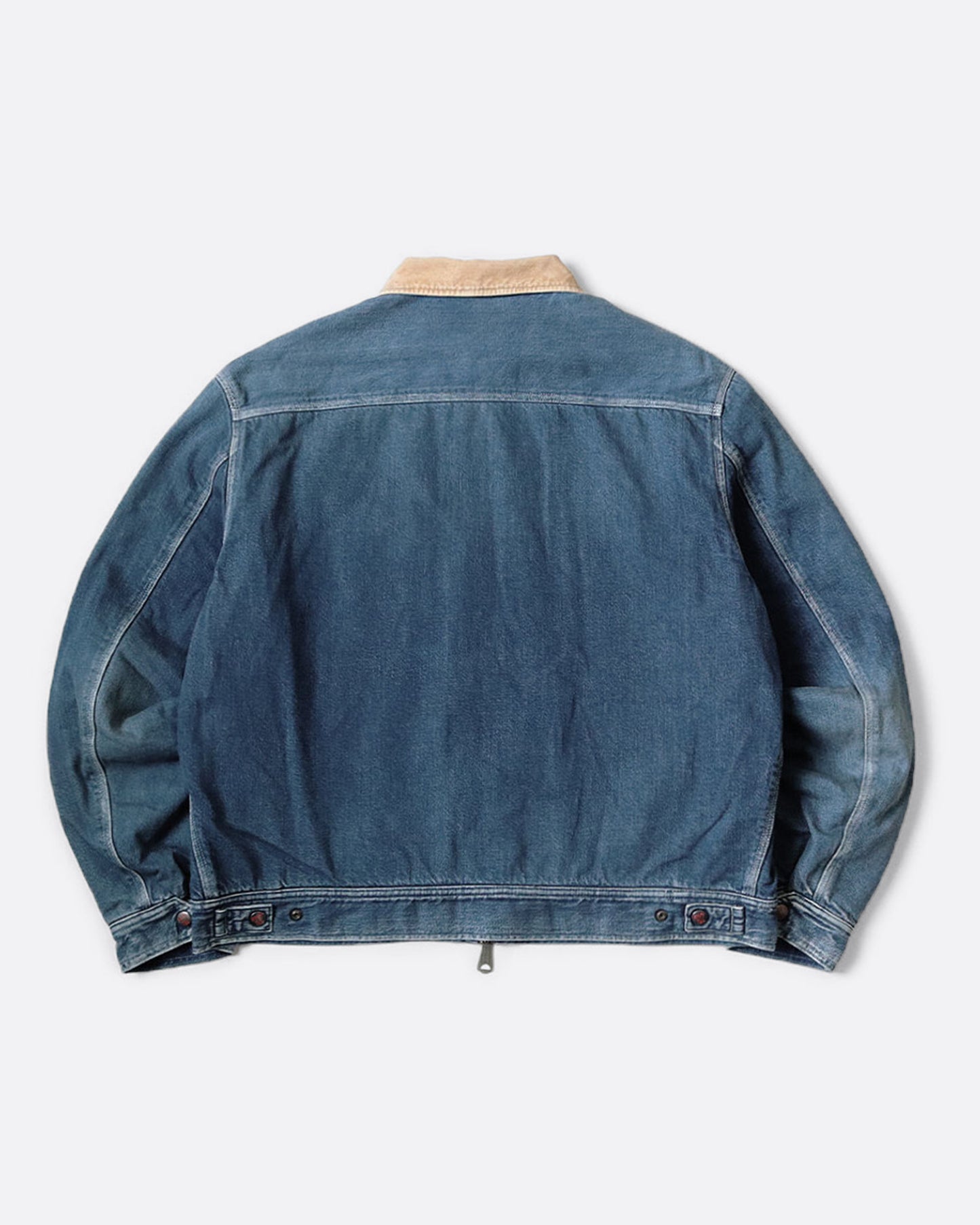 A blue denim work jacket with a beige collar, lined in wool with a skeleton print. Shown from the back.