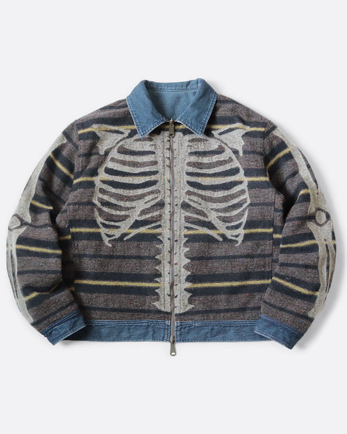 A blue denim work jacket with a beige collar, lined in wool with a skeleton print. Shown from the front, reversed.