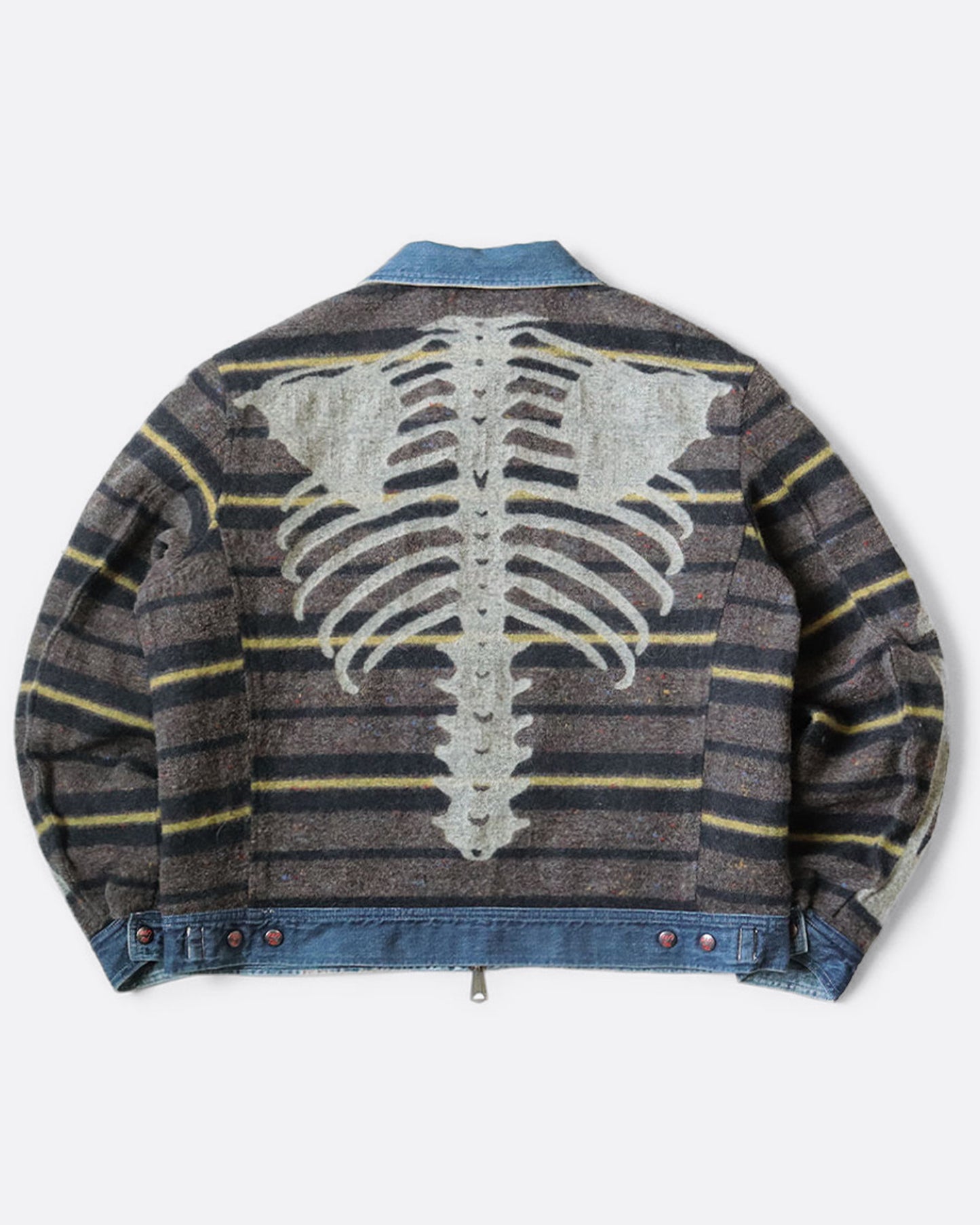 A blue denim work jacket with a beige collar, lined in wool with a skeleton print. Shown from the back, reversed.